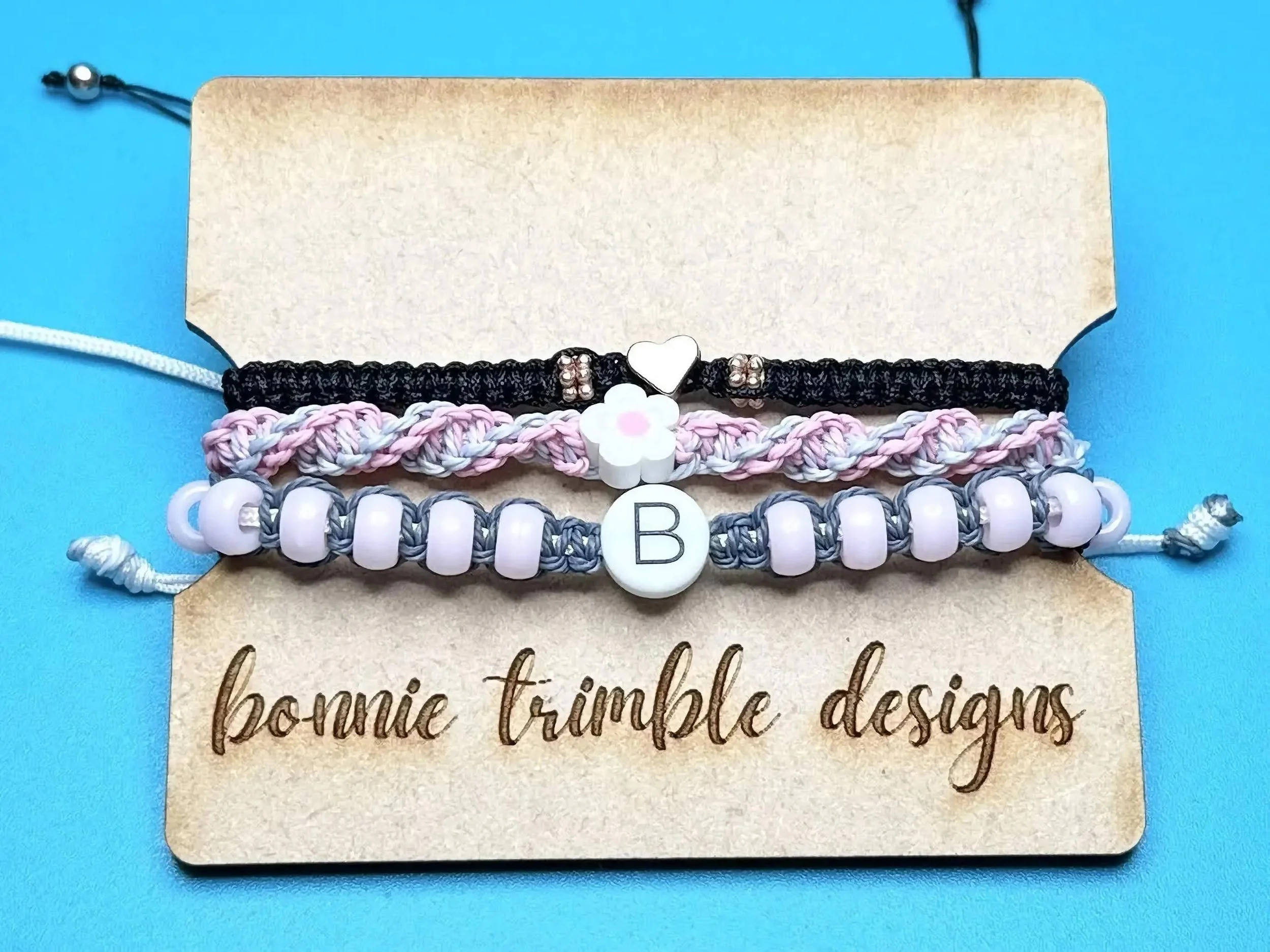 detailed view of the micro-macramé knots and the high-quality rose gold plating on the signature heart charm.