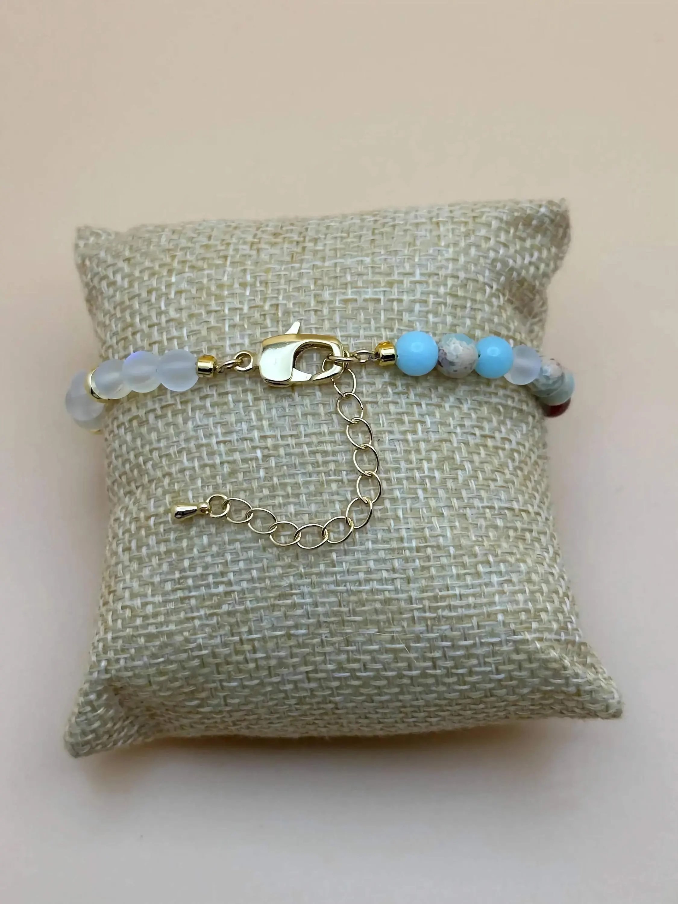 the whimsical dreamer bracelet styled against a dark starry background to emphasize its iridescent, celestial glow.