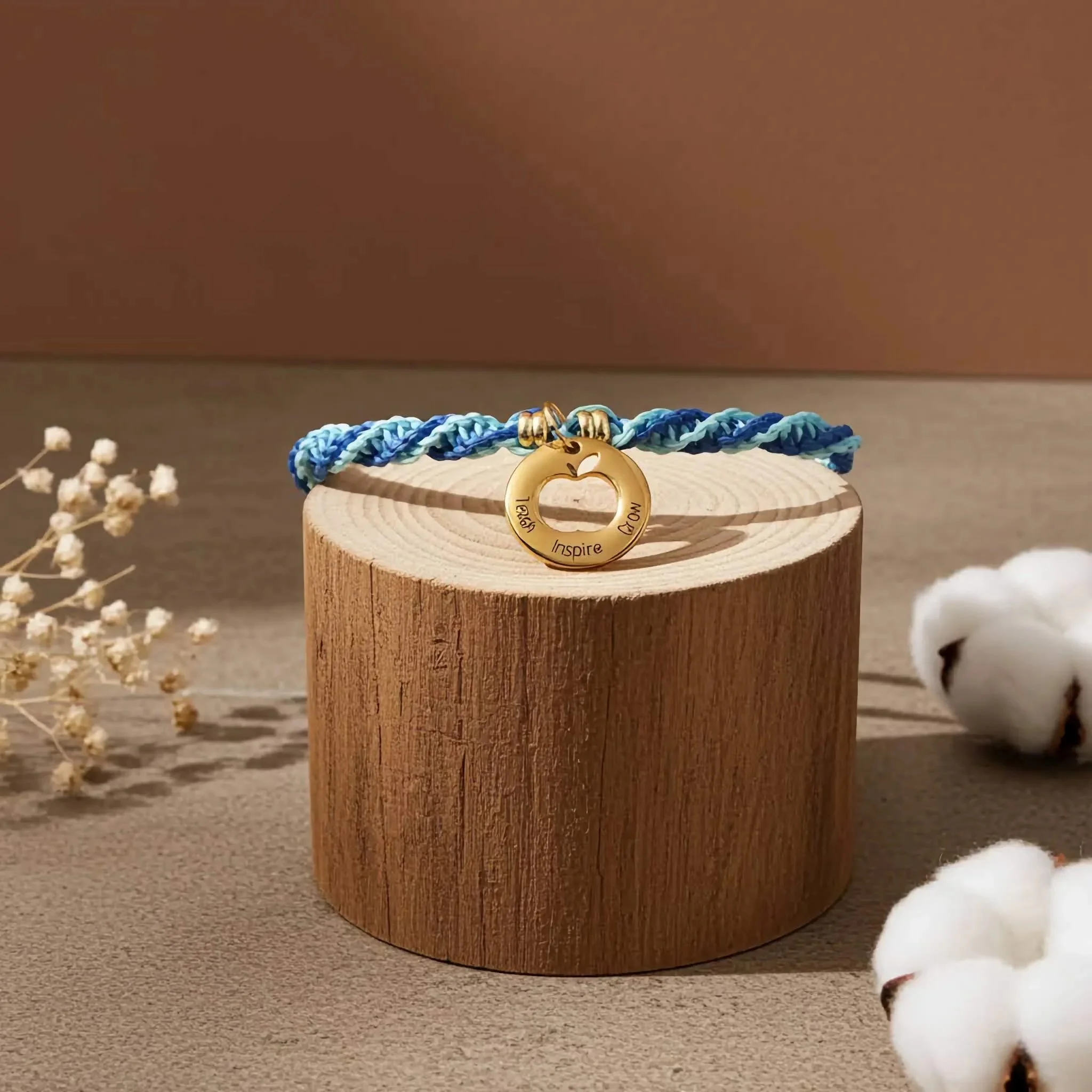 an adjustable, luxury-style teacher bracelet with a gold-tone focal charm and durable micro-macramé weaving.