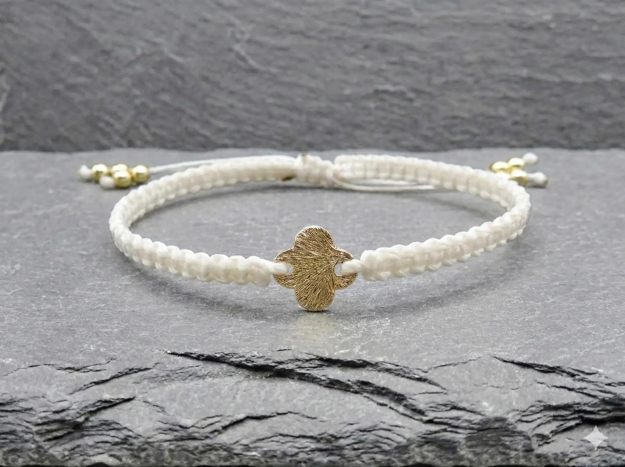 handcrafted intentional jewelry featuring an adjustable sliding knot closure and a tarnish-resistant brushed gold cross symbol.