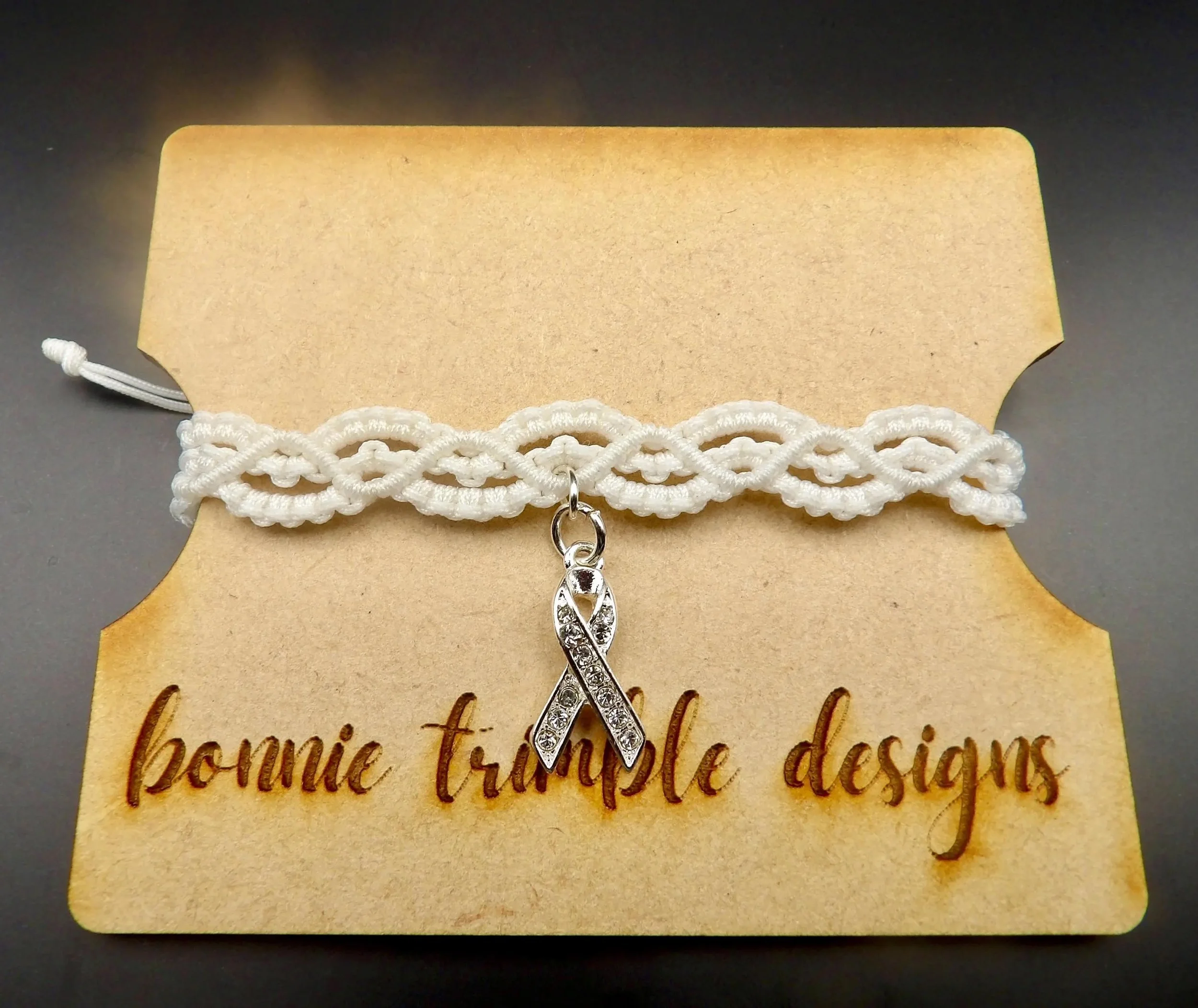 modern romantic jewelry featuring intricate white fiber weaving and a polished crystal ribbon for a sophisticated bridal or formal look.