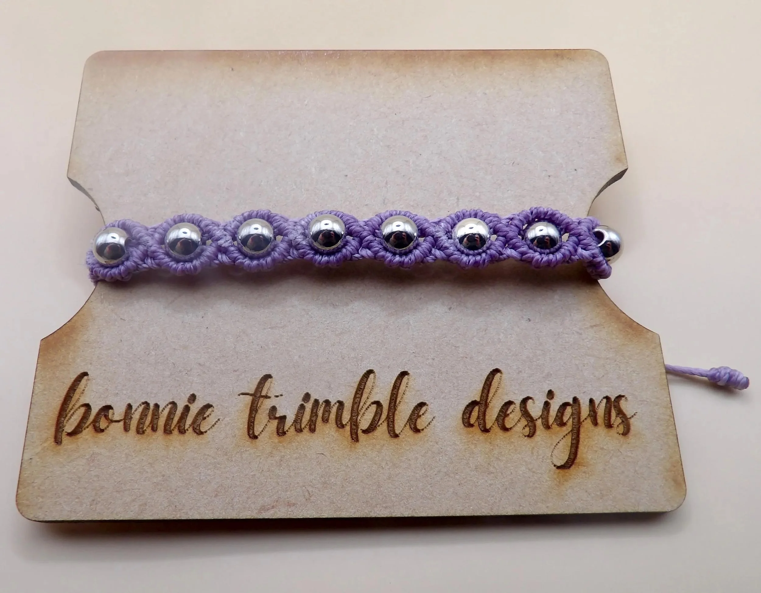 waterproof stainless steel bead bracelet with a structural micro-macramé design, ideal for an active lifestyle.