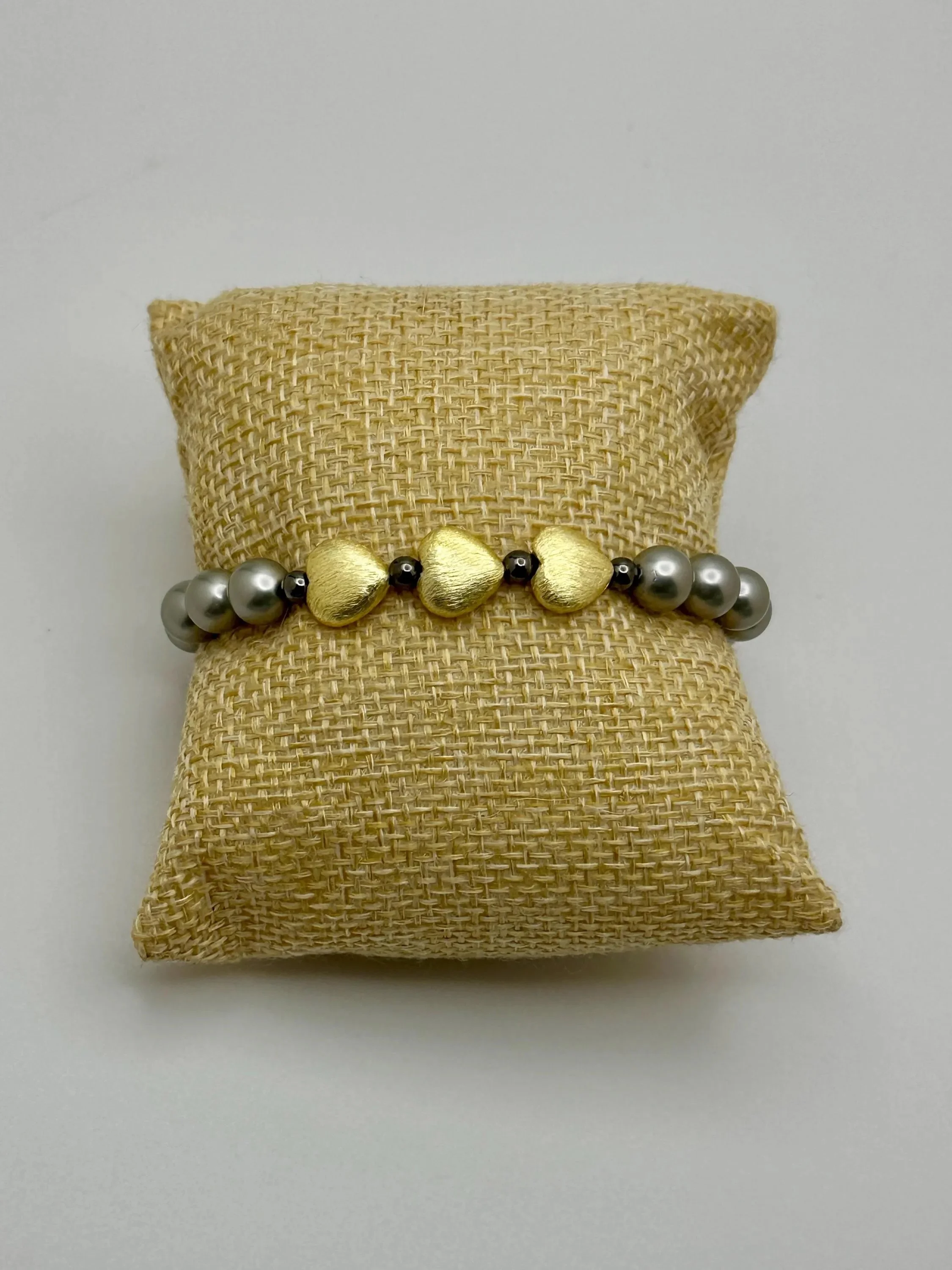 the dark romantic bracelet styled on a black velvet background to showcase its moody, iridescent shimmer.