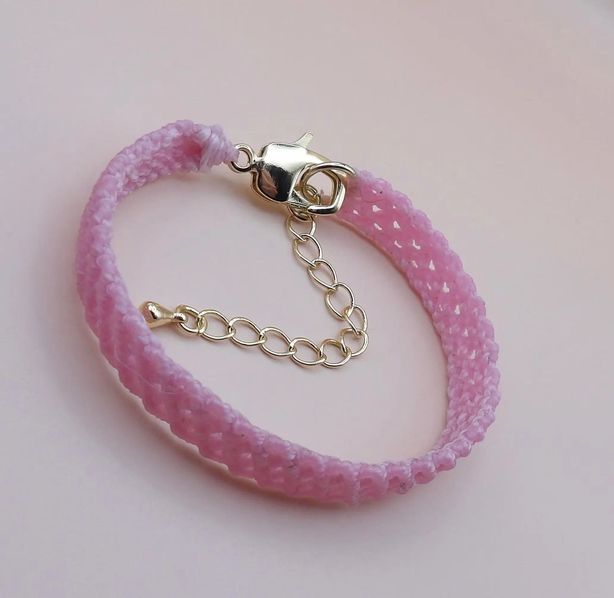 detailed view of the baby pink micro-macramé structure and the polished 18k gold filled lobster clasp and extender.