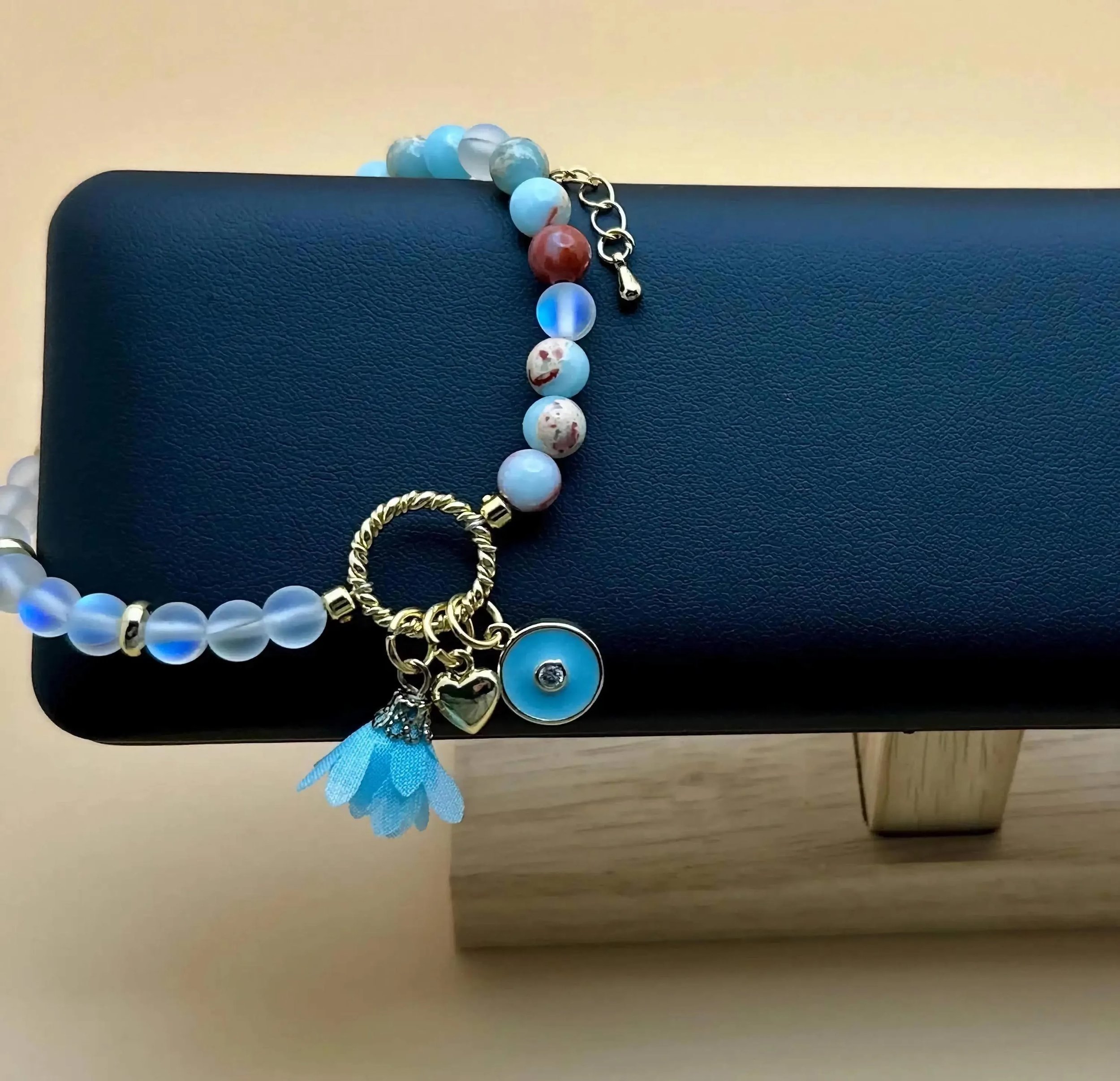 an adjustable, ethereal gemstone bracelet featuring a "dreamer" charm cluster with light-catching spectrolite and opal.