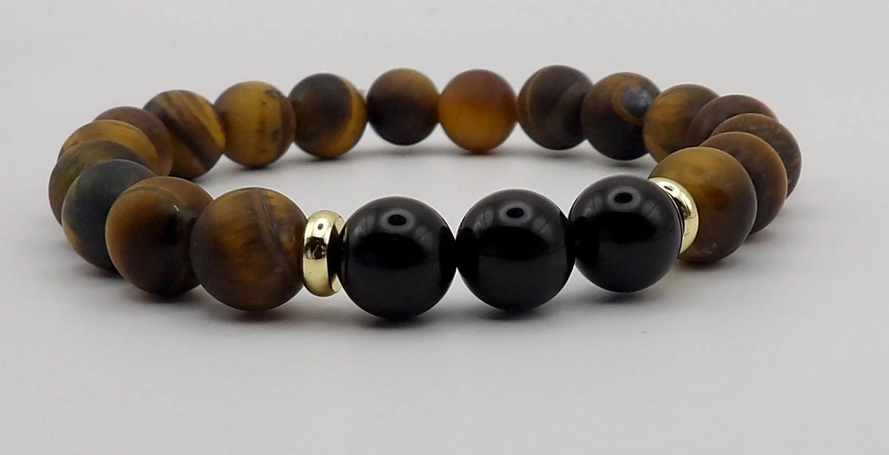 the balanced stoic bracelet styled with a luxury watch to demonstrate its "executive armor" aesthetic.
