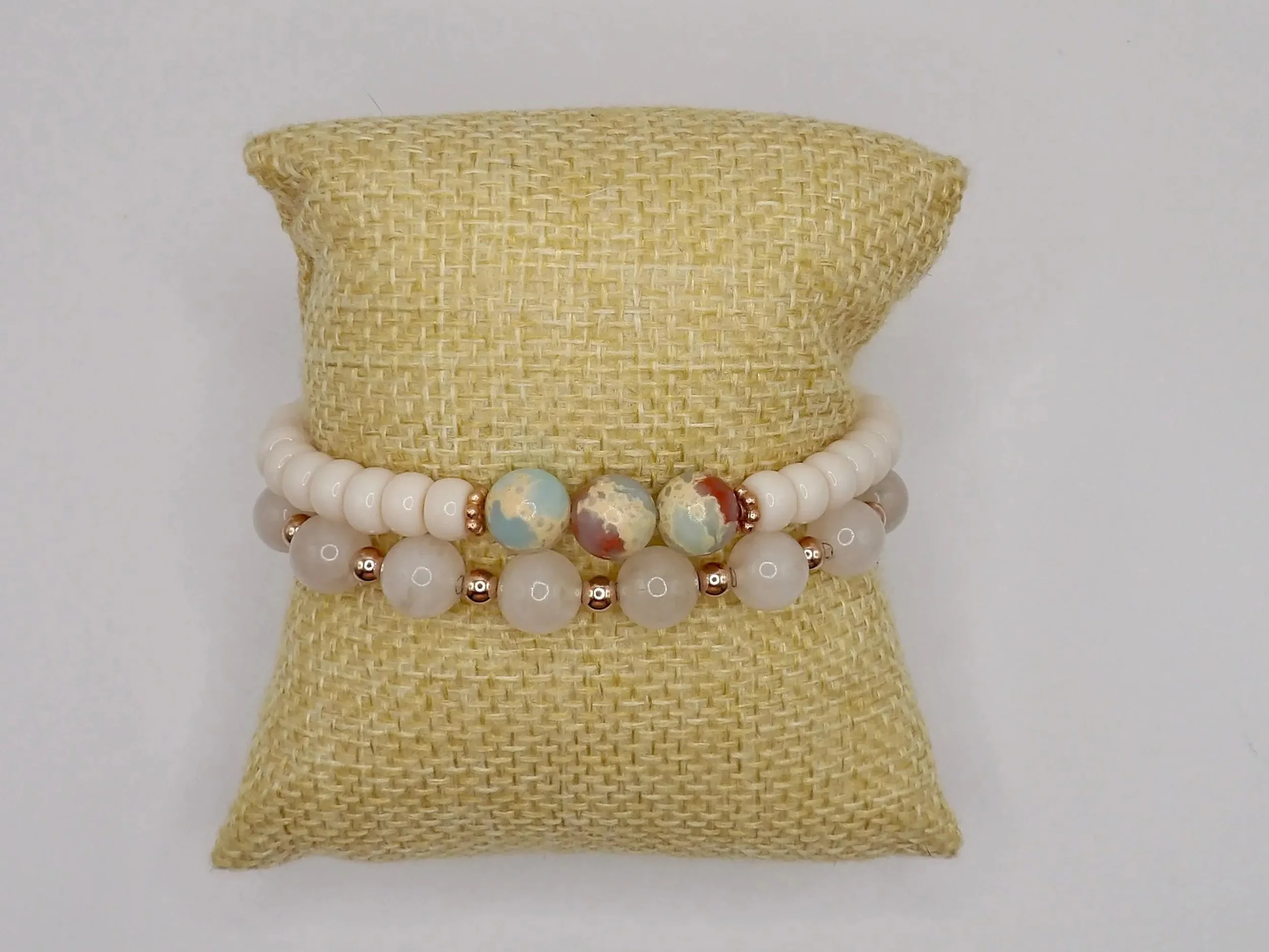 a serene coastal jewelry piece showing the natural blue and brown variegation of african opal against matte cream beads.