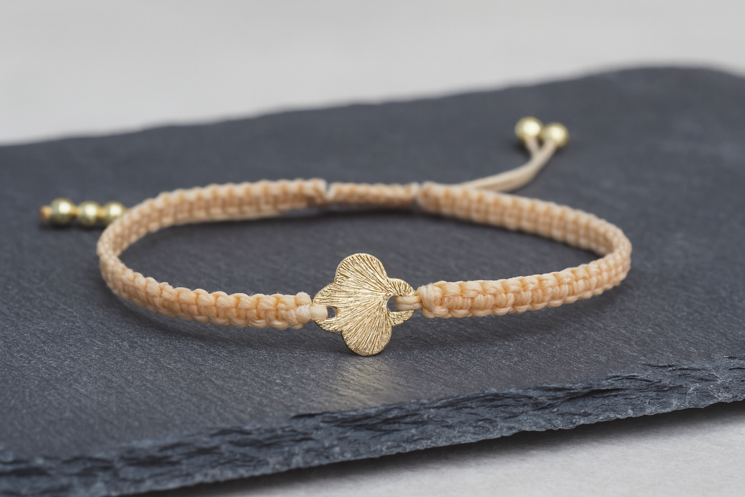 the brushed gold greek cross macramé bracelet | beige cord + gold accents