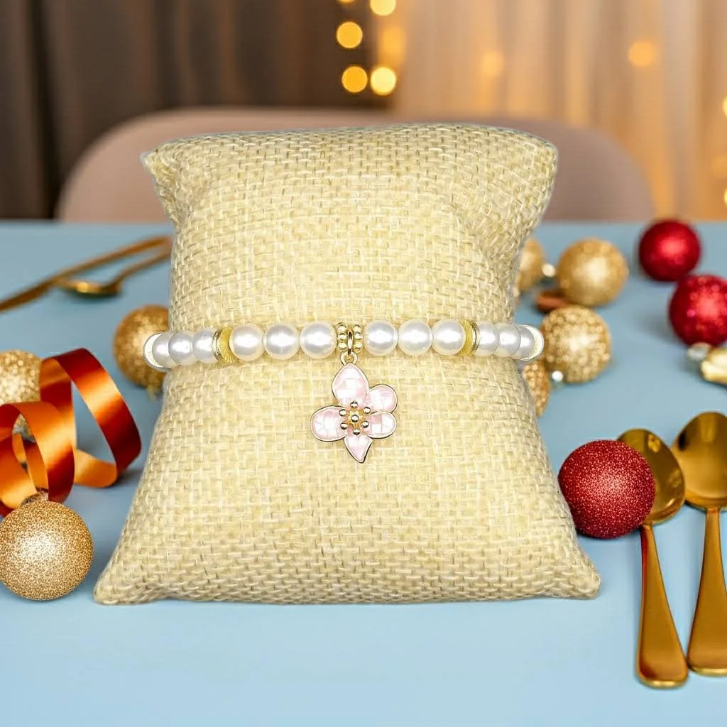 christmas holiday photo of handmad pearl and 18k gold bracelet with hanging pink flower charm.