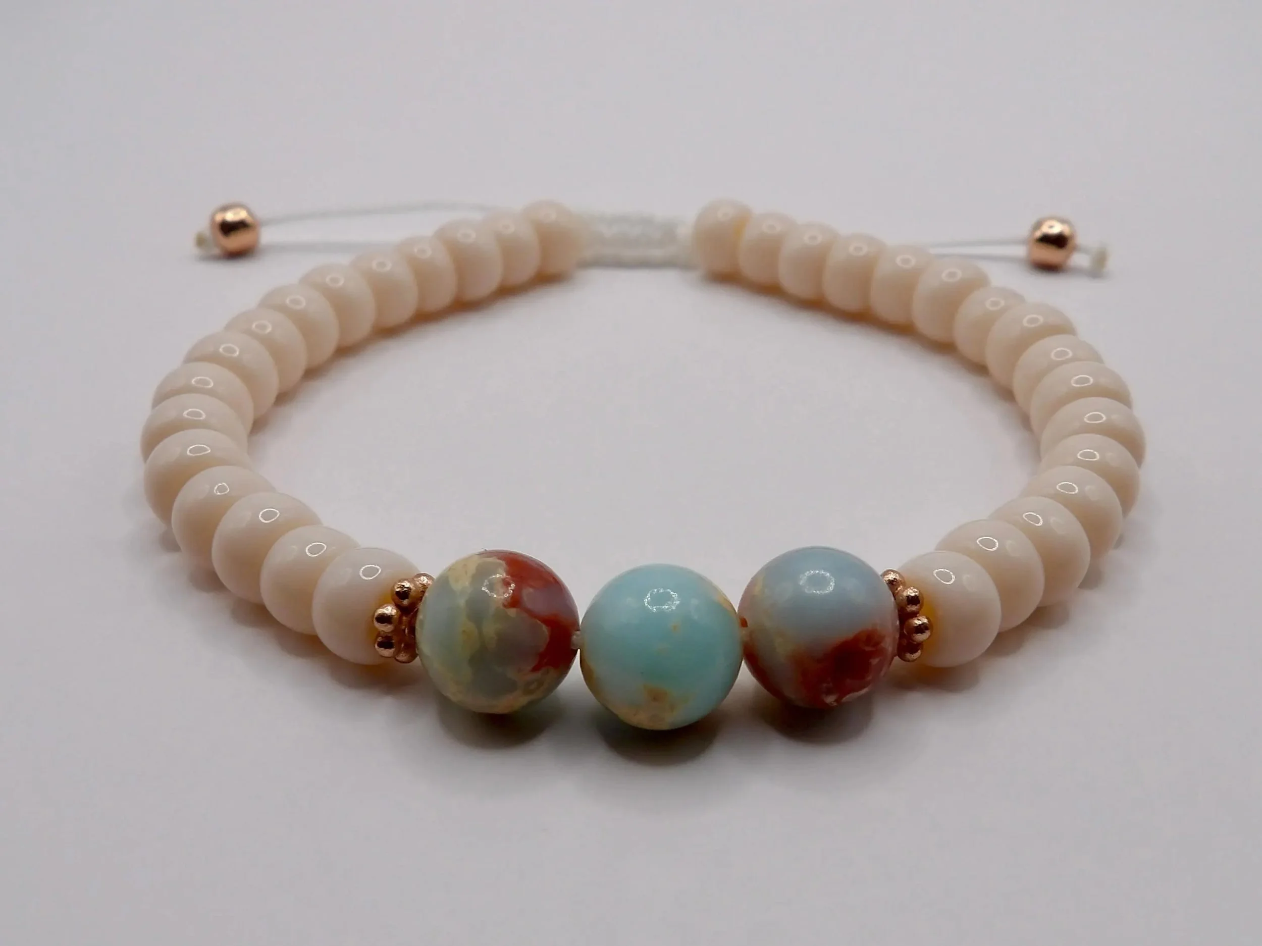 handcrafted adjustable bracelet with a rose gold finish, featuring high-quality blue african opal for a "coastal luxe" aesthetic.