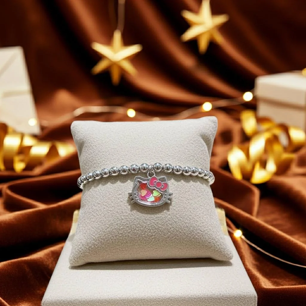 handcrafted 925 sterling silver jewelry featuring an authentic hello kitty shaker charm and secure silver lobster clasp.