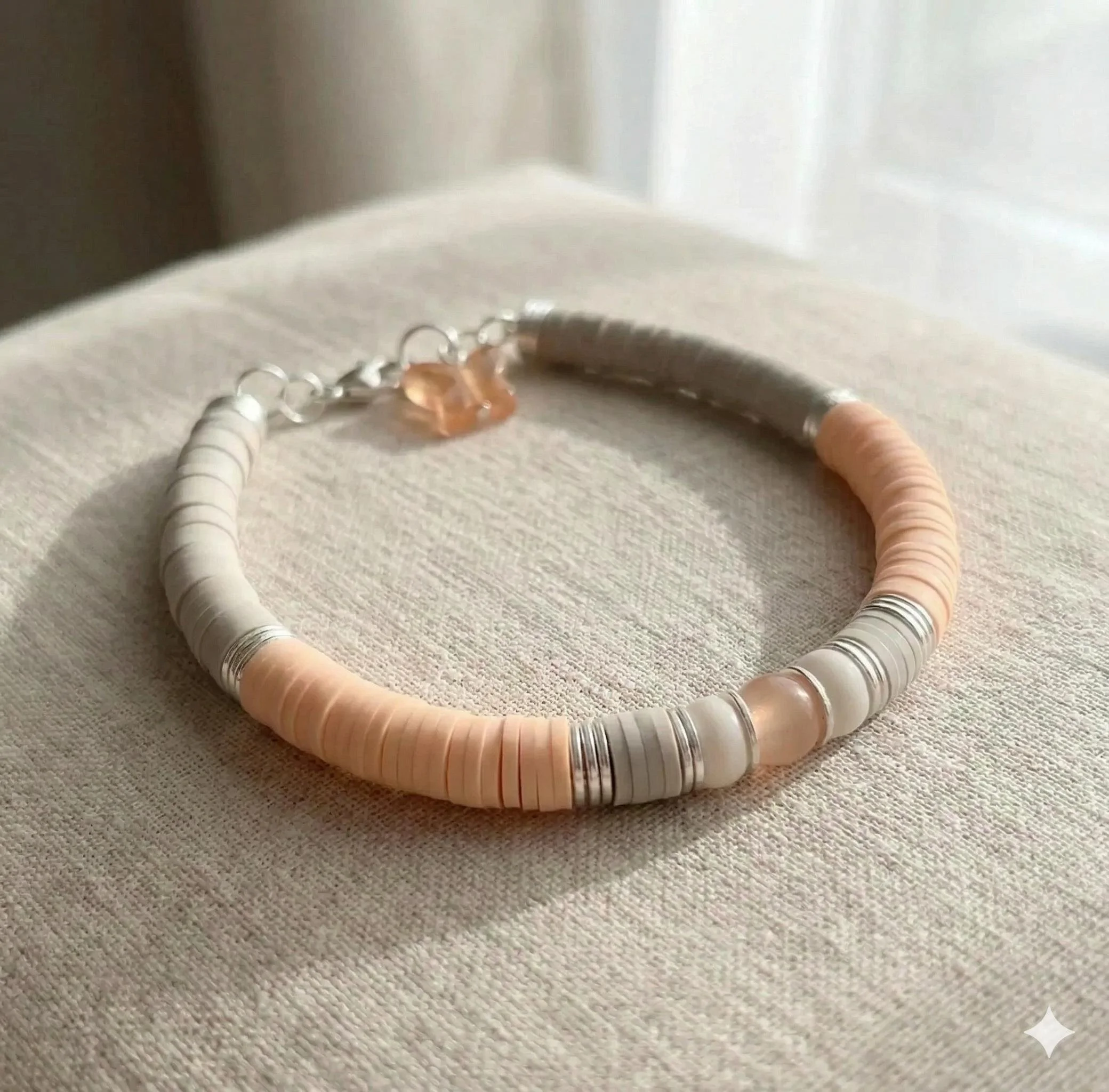 the butterfly custom bracelet featuring a .925 sterling silver butterfly charm and vibrant handmade heishi beads in a color of your choice.