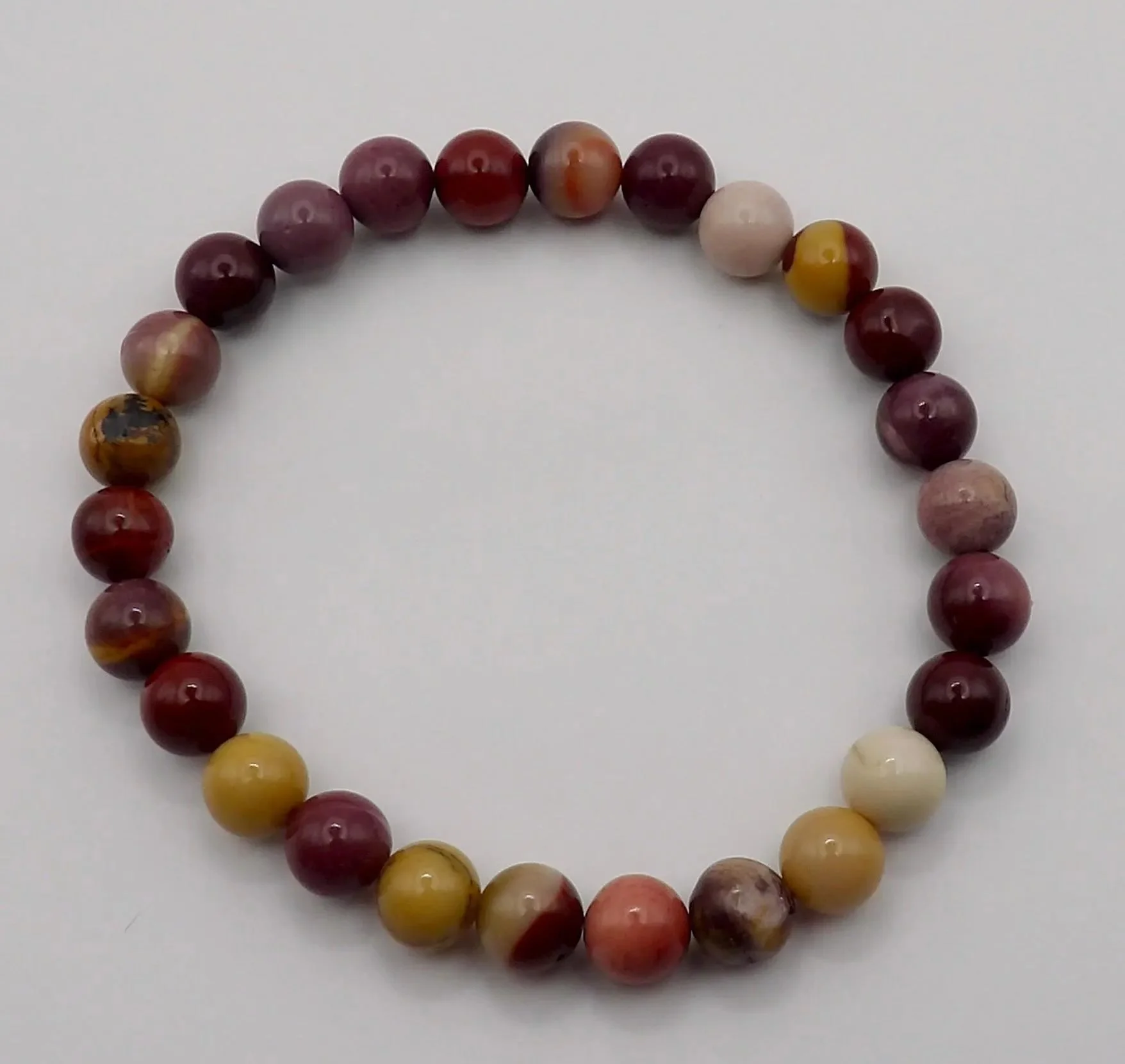 a dainty stretch bracelet featuring 6mm australian mookaite jasper, designed for a subtle boho-minimalist look.