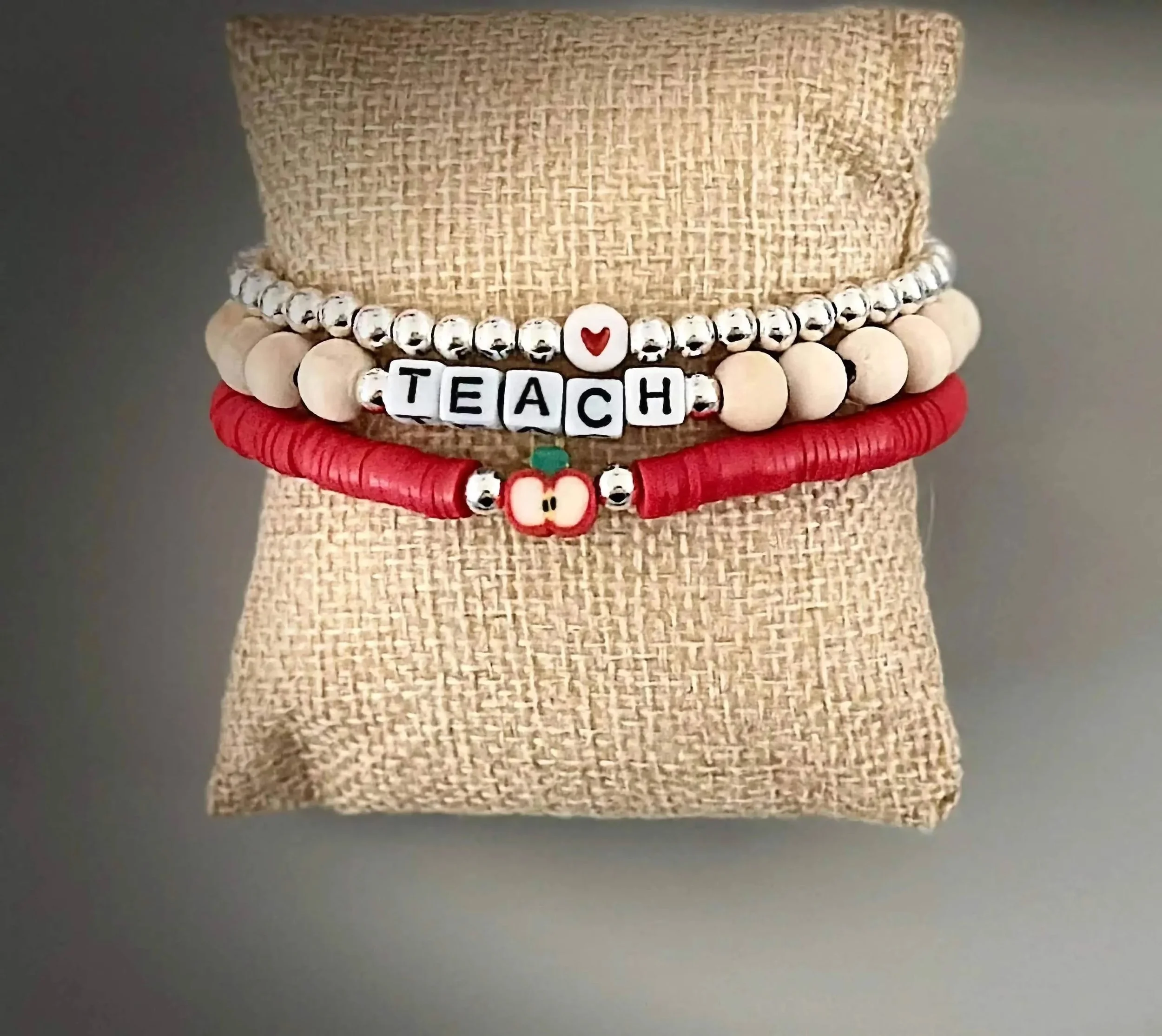 artisan 925 sterling silver teacher jewelry featuring a handcrafted bead stack and a sculptural red apple focal charm.