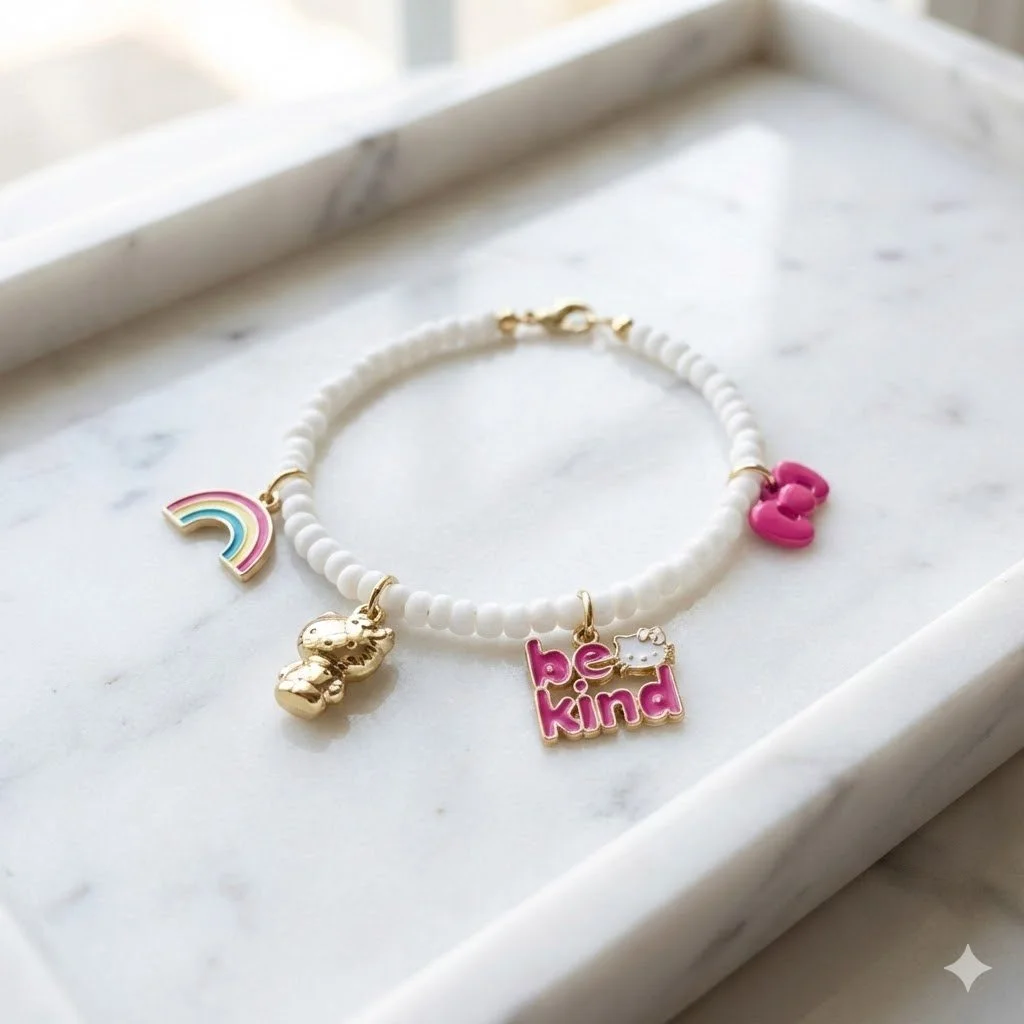 the cheerful collector bracelet | 18k gold plated hello kitty charms + white seed beads | playful sanrio luxury