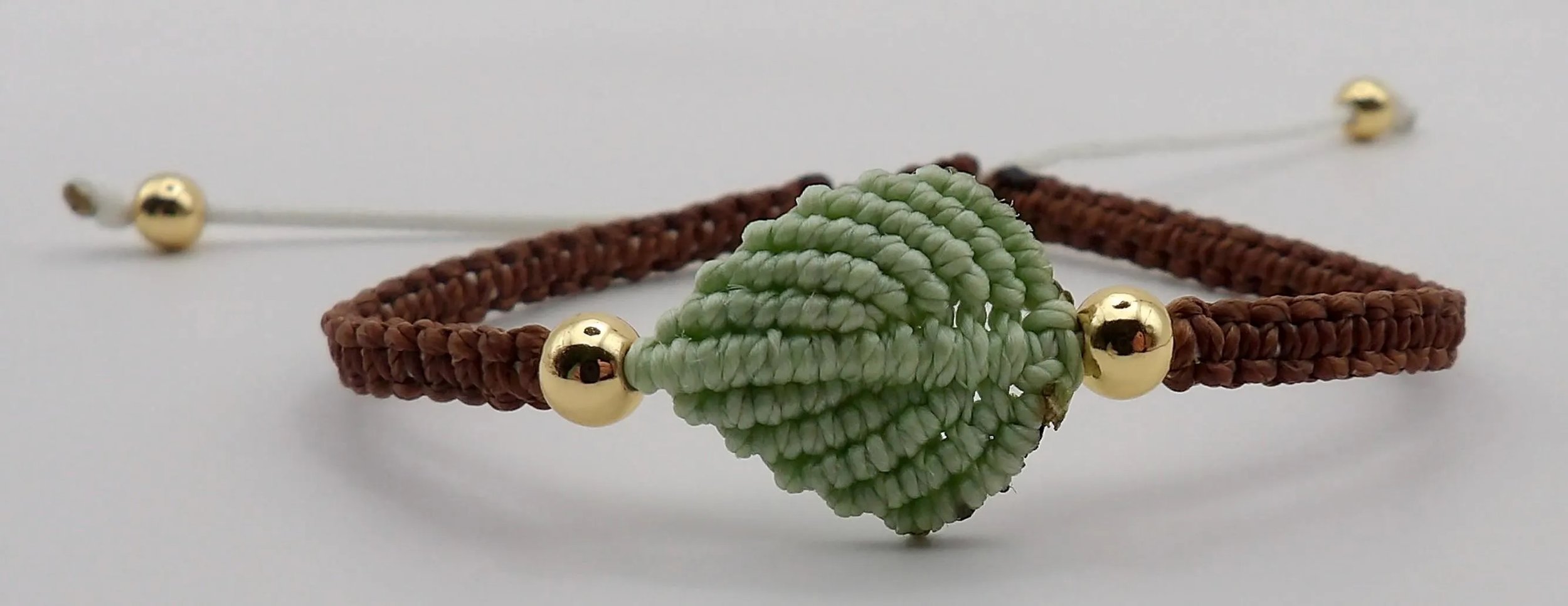 boho botanical leaf duo with gold-plated bead details and adjustable closures for a custom fit.