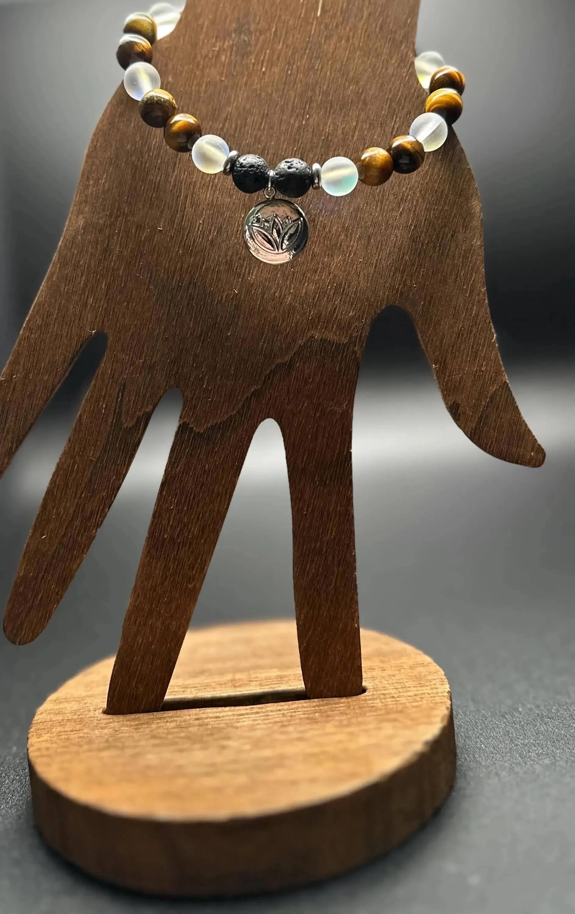 a unisex grounding talisman featuring natural earth-toned gemstones and an industrial-strength stainless steel lotus charm.