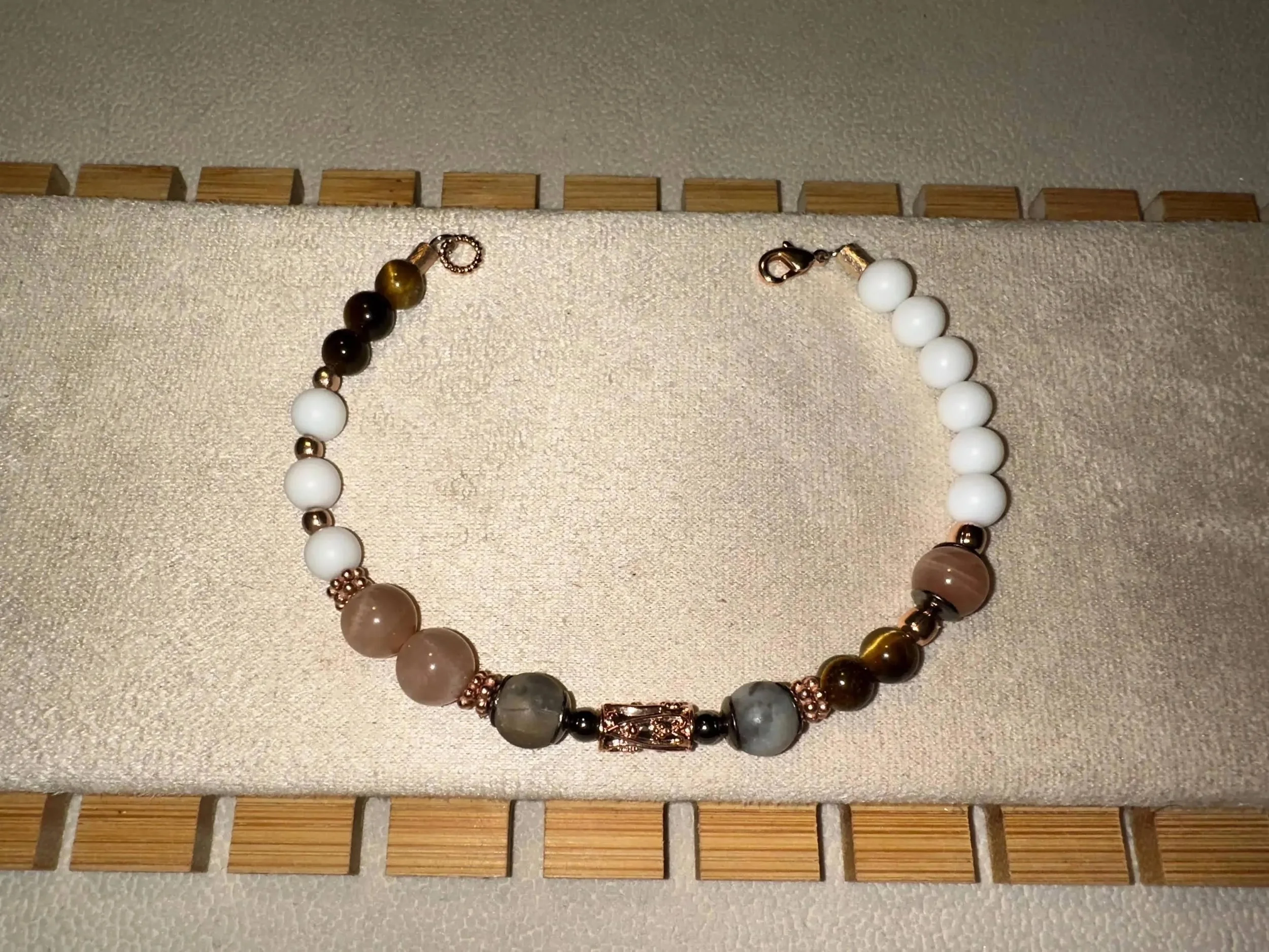 the free spirit bracelet styled on a textured sandstone background to emphasize its raw, earthy, and sun-drenched aesthetic.