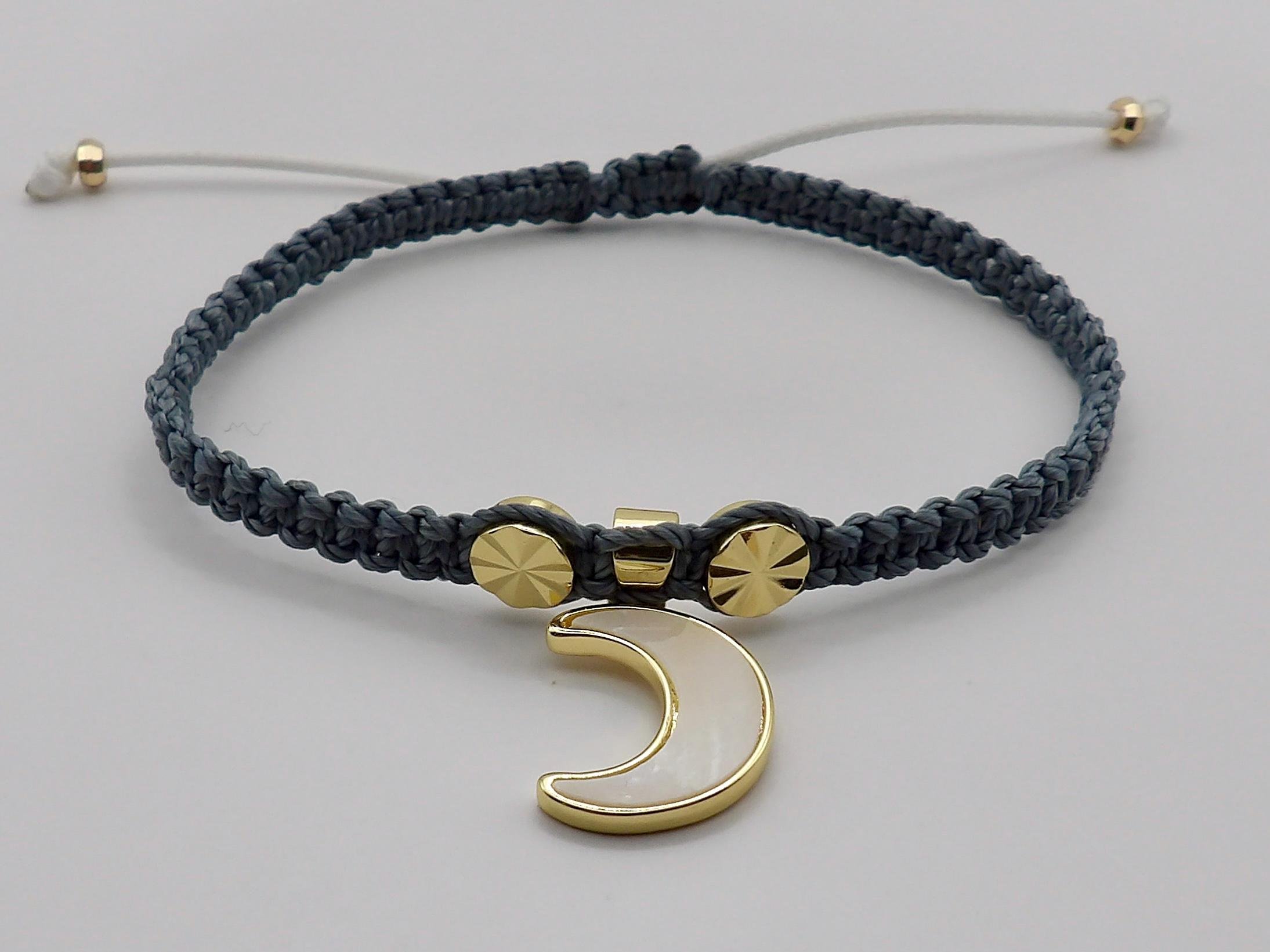 Waterproof charcoal gray macramé bracelet with 18k gold plated celestial charms, designed for style and daily durability.
