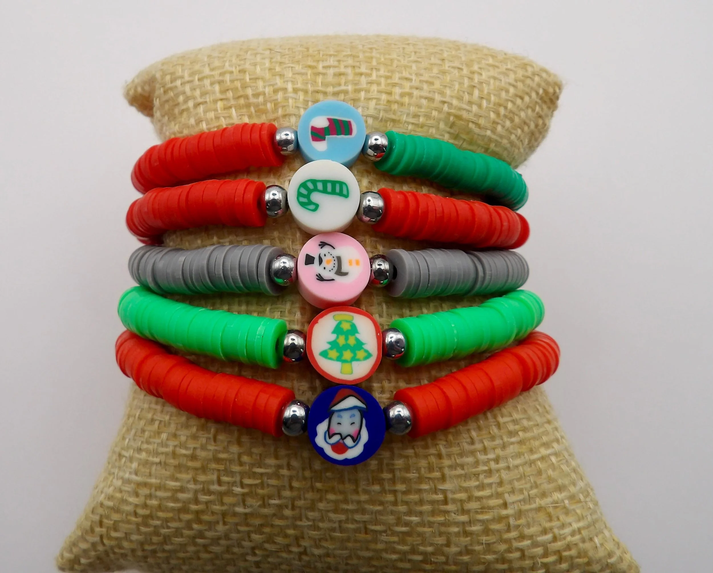 a colorful christmas-themed heishi bracelet with a seasonal focal bead and a cheerful, festive aesthetic.