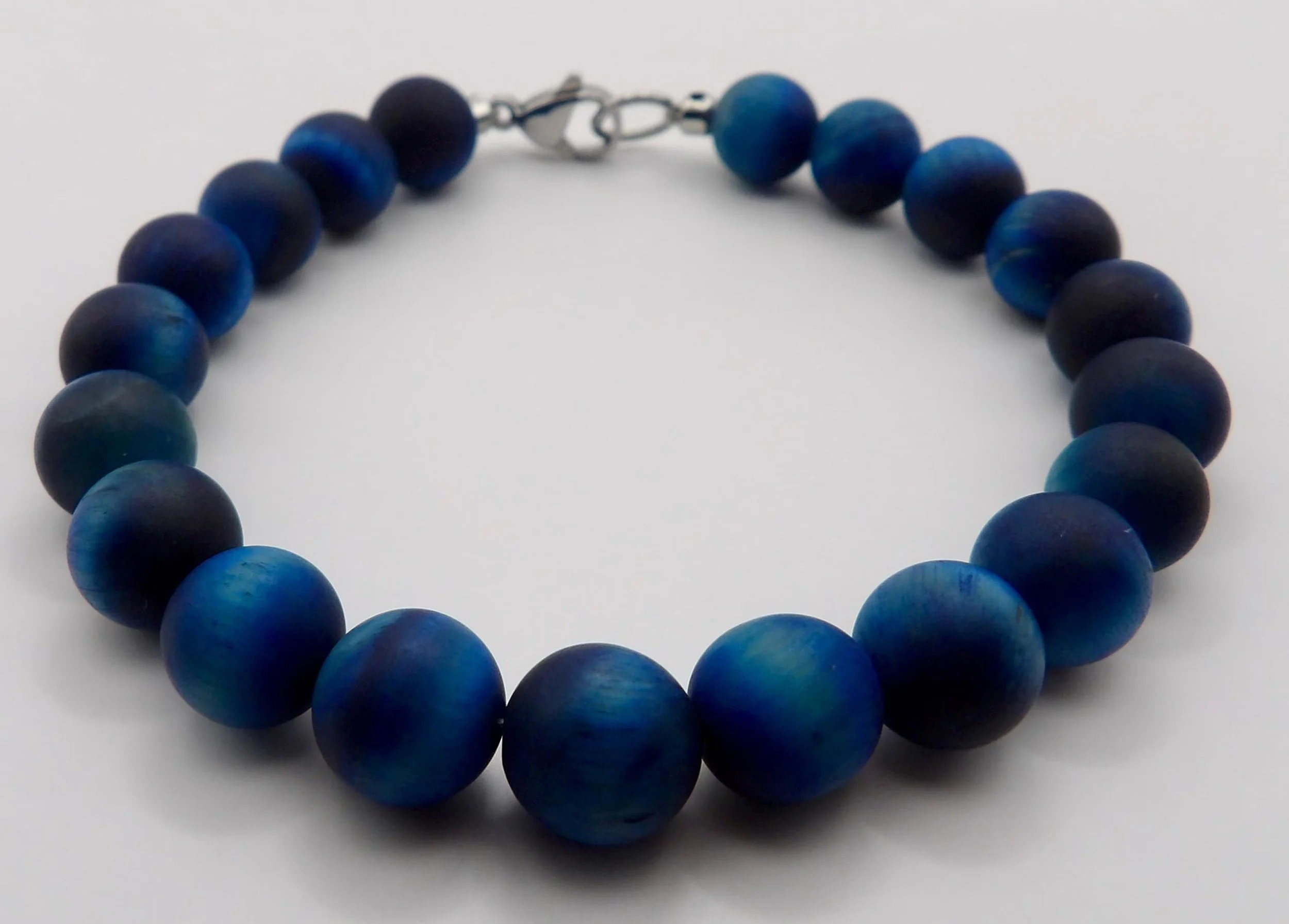 A professional lifestyle shot of the stoic protector bracelet, showcasing a deep navy and silver color palette for a resilient aesthetic.