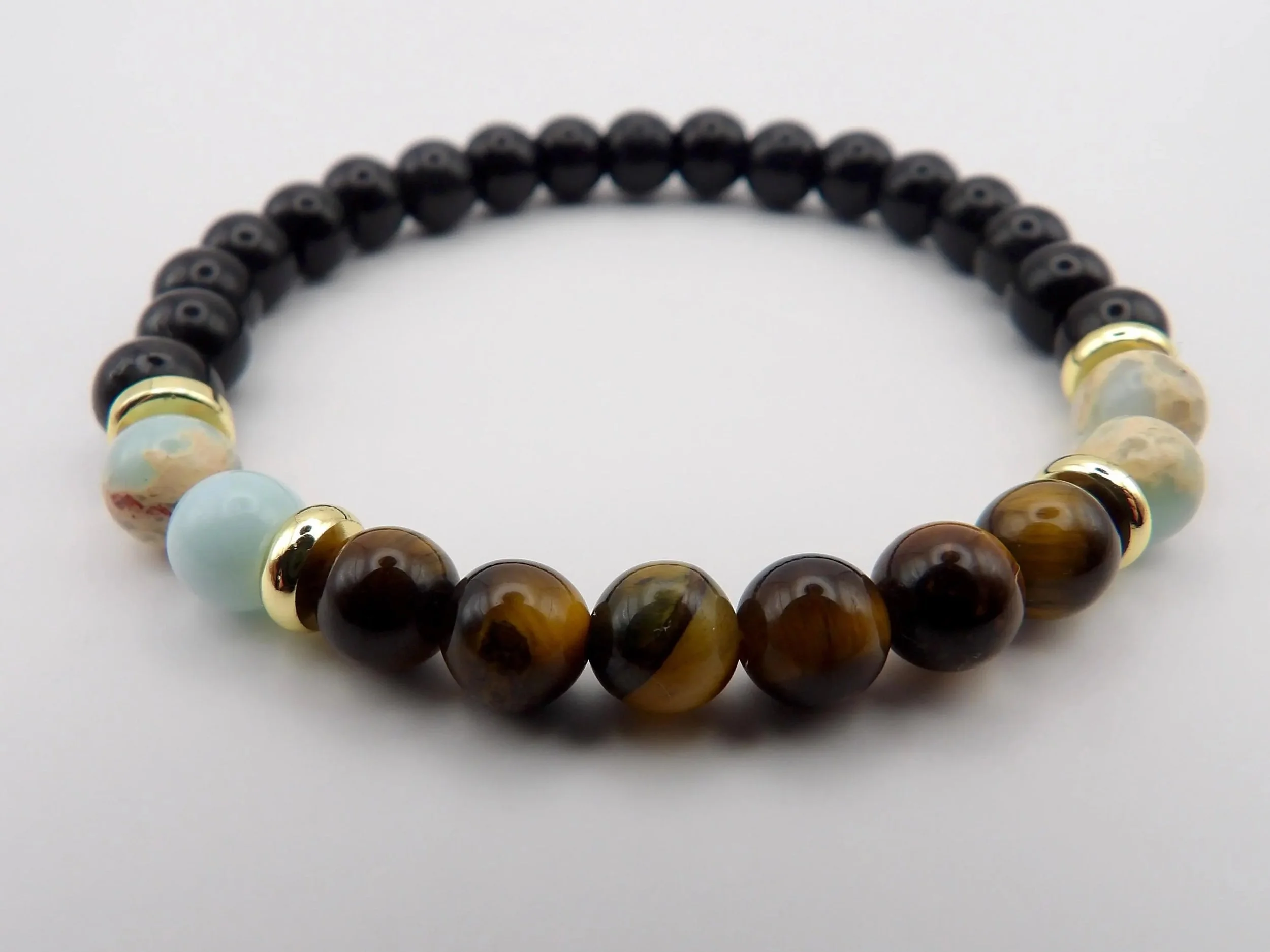 a modern take on earthy style featuring 18k gold plated hardware and deep black glass beads for a polished, everyday look.