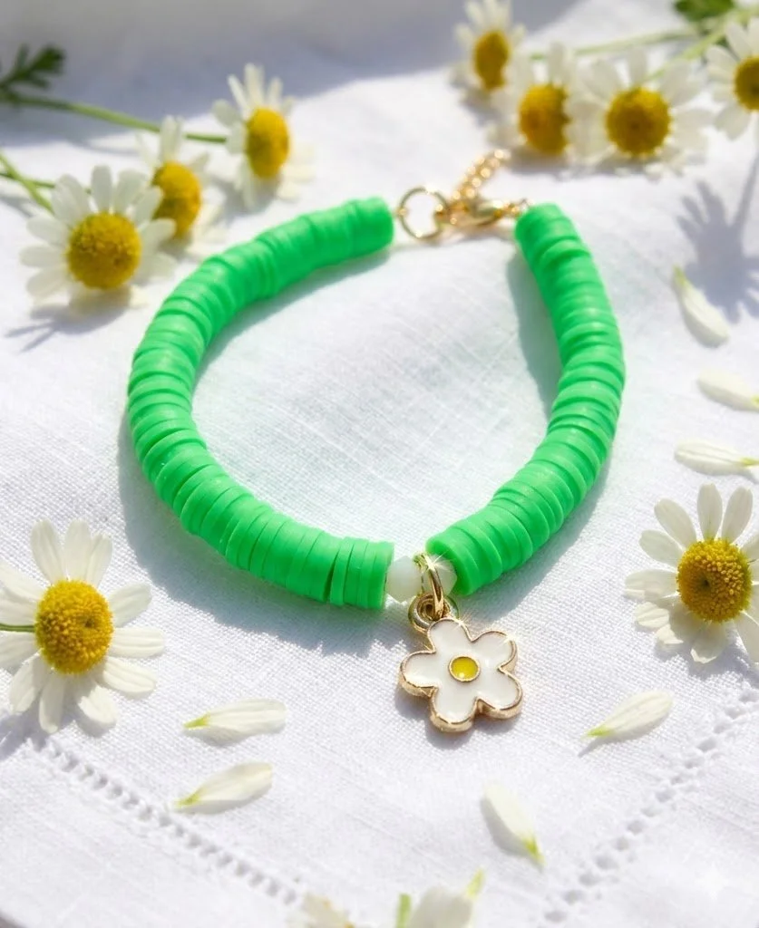 Handmade 14k solid gold daisy bracelet with grassy green heishi beads and sparkling crystals. Dainty floral fine jewelry.