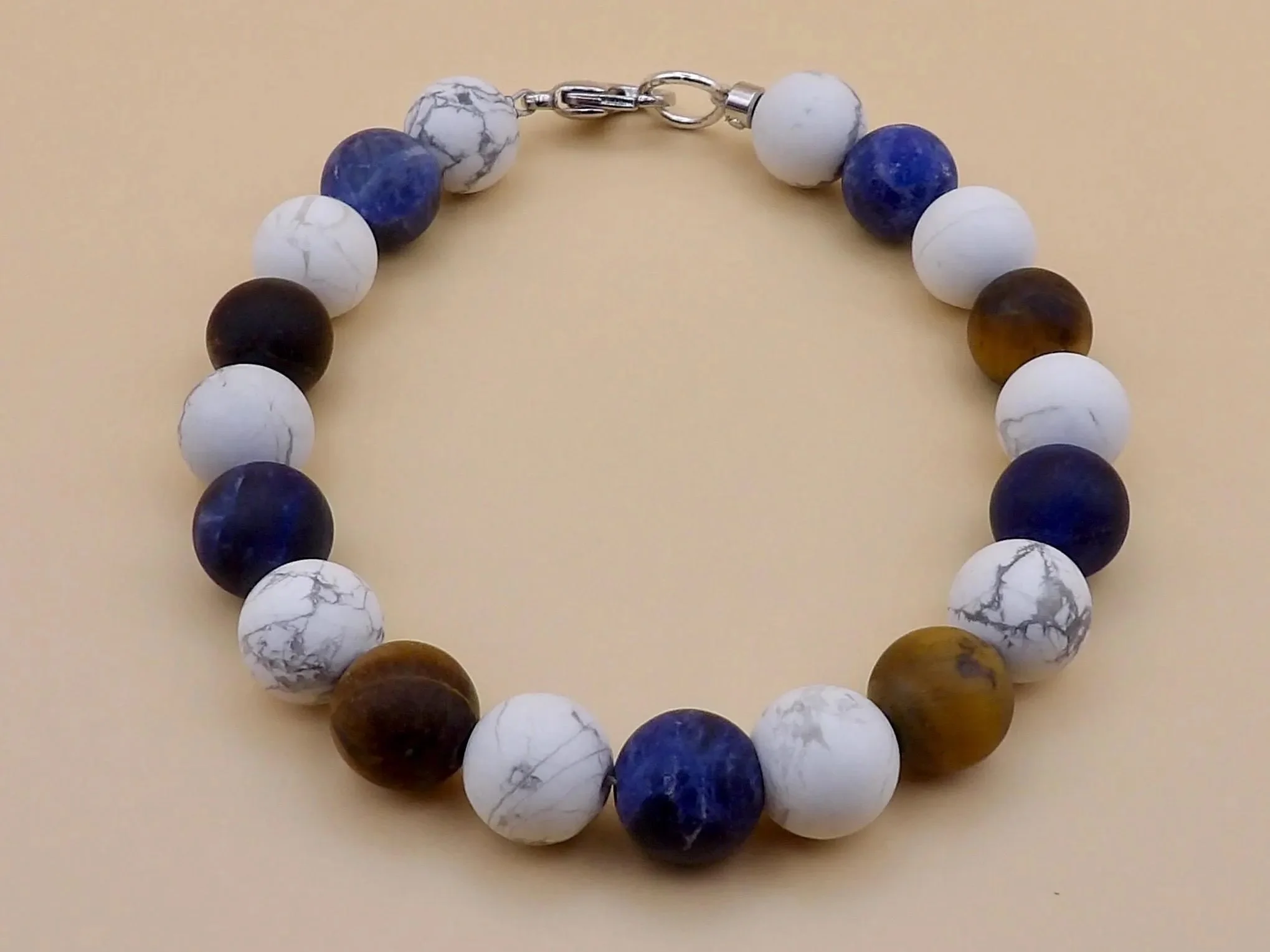 close-up of the modern stoic bracelet highlighting the durable stainless steel hardware and the rich, earthy tones of the stones.