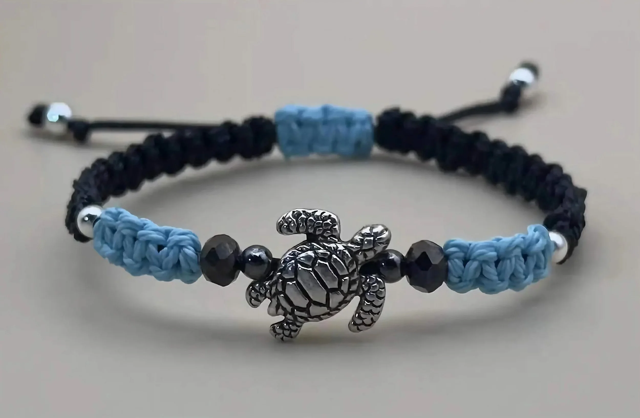 the ocean soul bracelet styled with beach gear to emphasize its "ocean-hearted" aesthetic and durable construction.