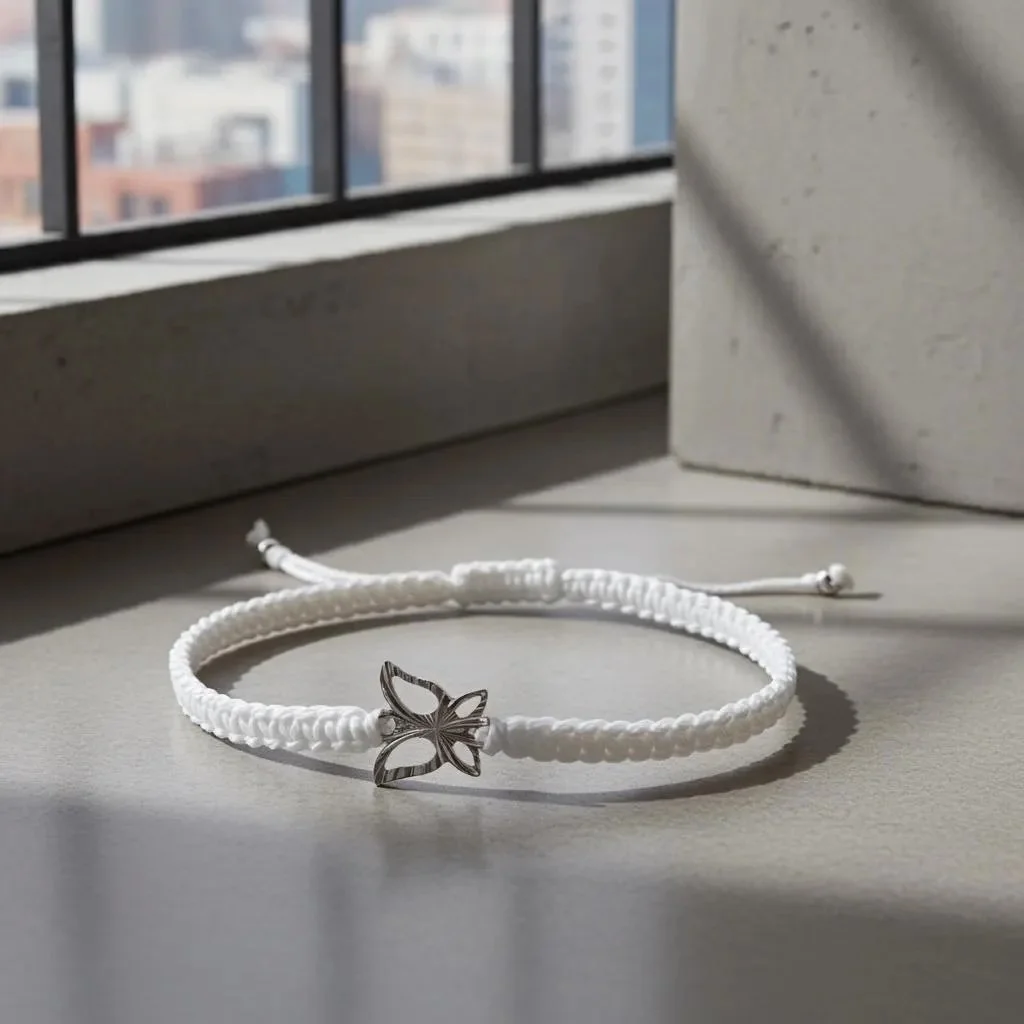 handcrafted sterling silver butterfly bracelet with a minimalist white woven anchor for a "clean girl" aesthetic.