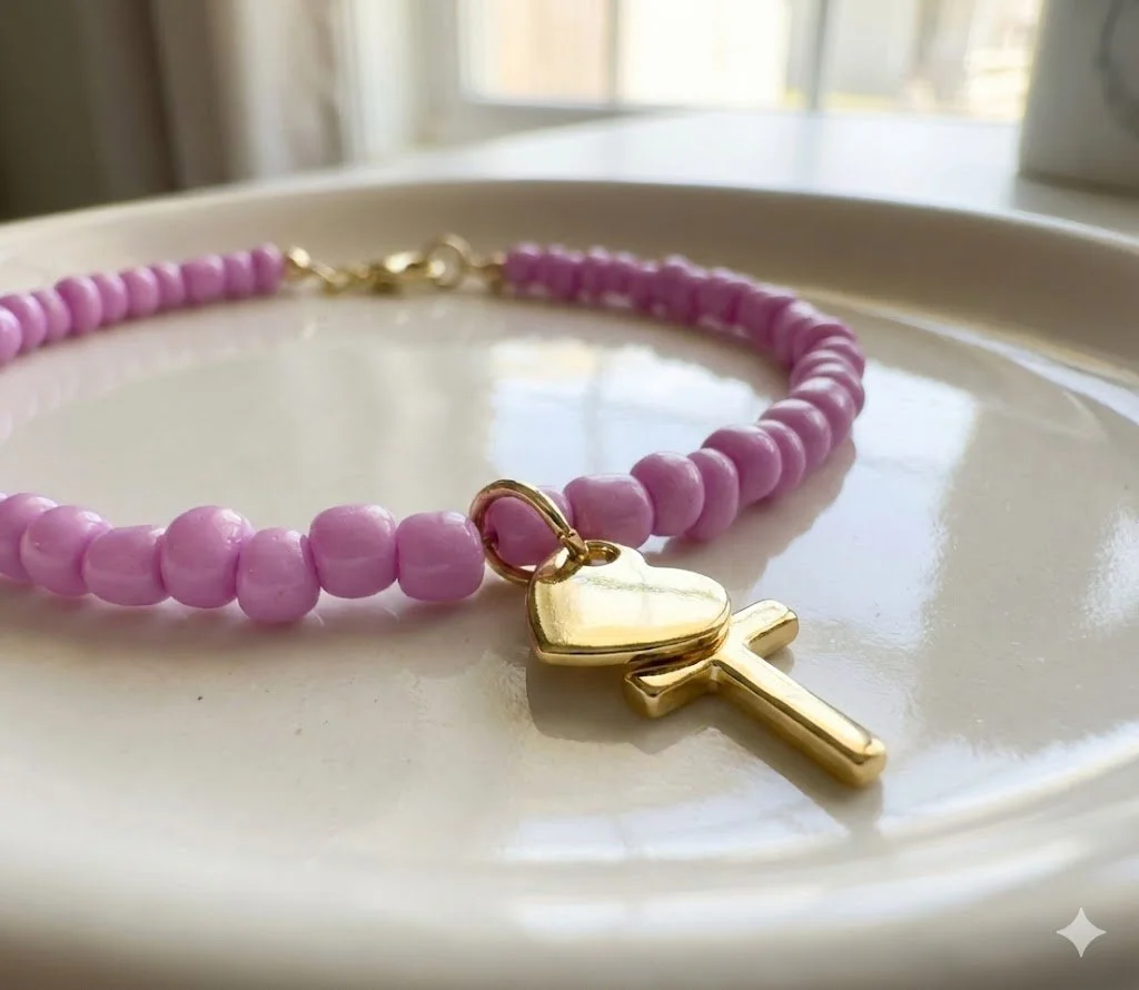 handmade dainty seed bead bracelet in lilac (custom colors available) featuring hanging 18k gold cross and heart charms.