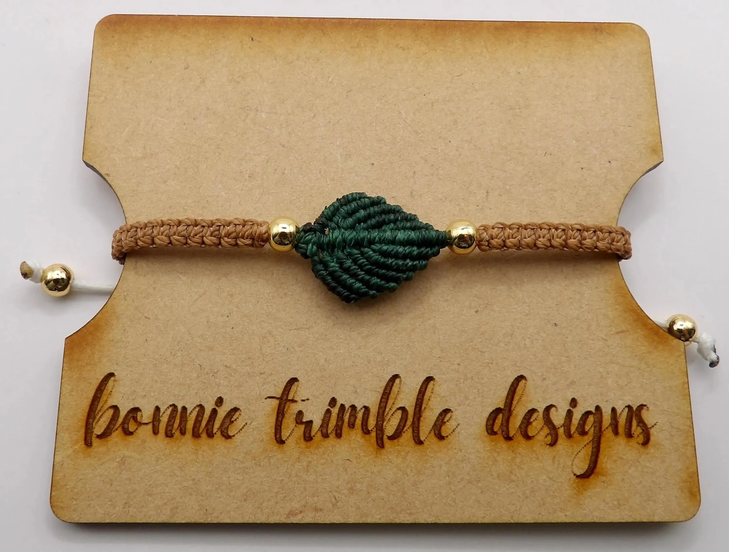 nature-inspired green and brown leaf bracelet duo showing the delicate textural detail of artisan fiber weaving.
