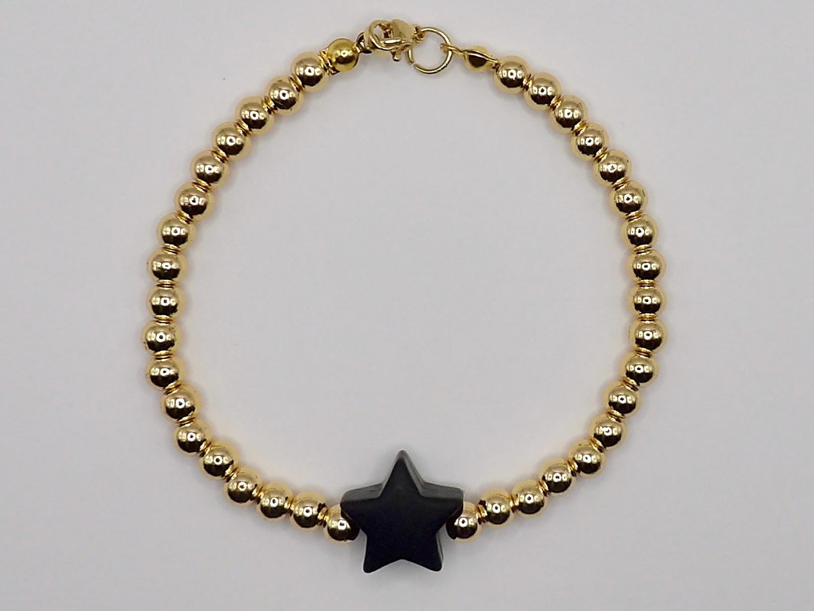 playful star jewelry showing the contrast between metallic gold beads and a bright silicone star focal.