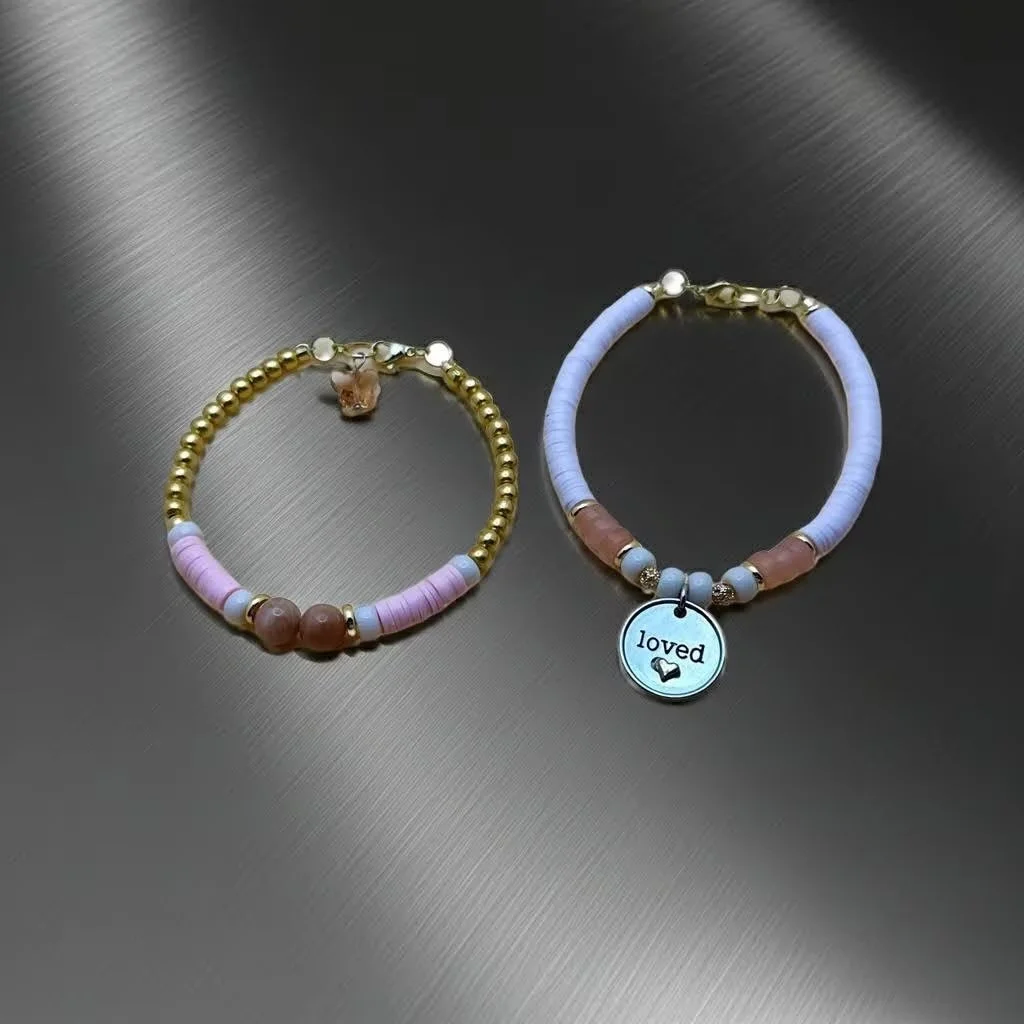 close-up of the loved and lifted set highlighting the delicate gold butterfly charm and the faceted texture of the sunstone.