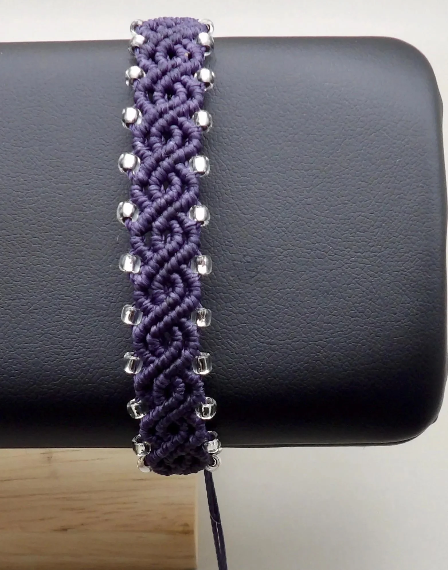 the bohemian artisan bracelet styled in a "modern folk" look, emphasizing its rich texture and subtle metallic shimmer.
