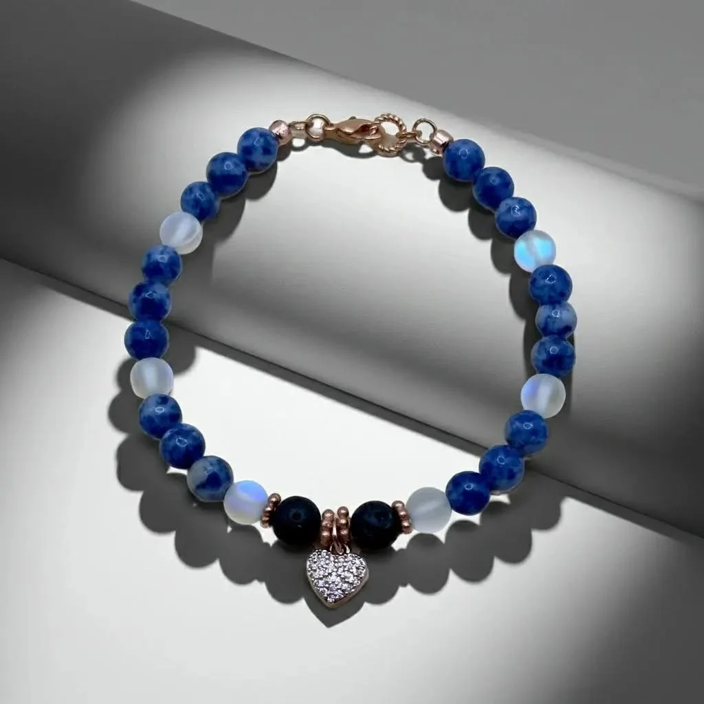 a luxury blue opal charm cluster bracelet with high-shine gold-filled beads and a minimalist anchor design.