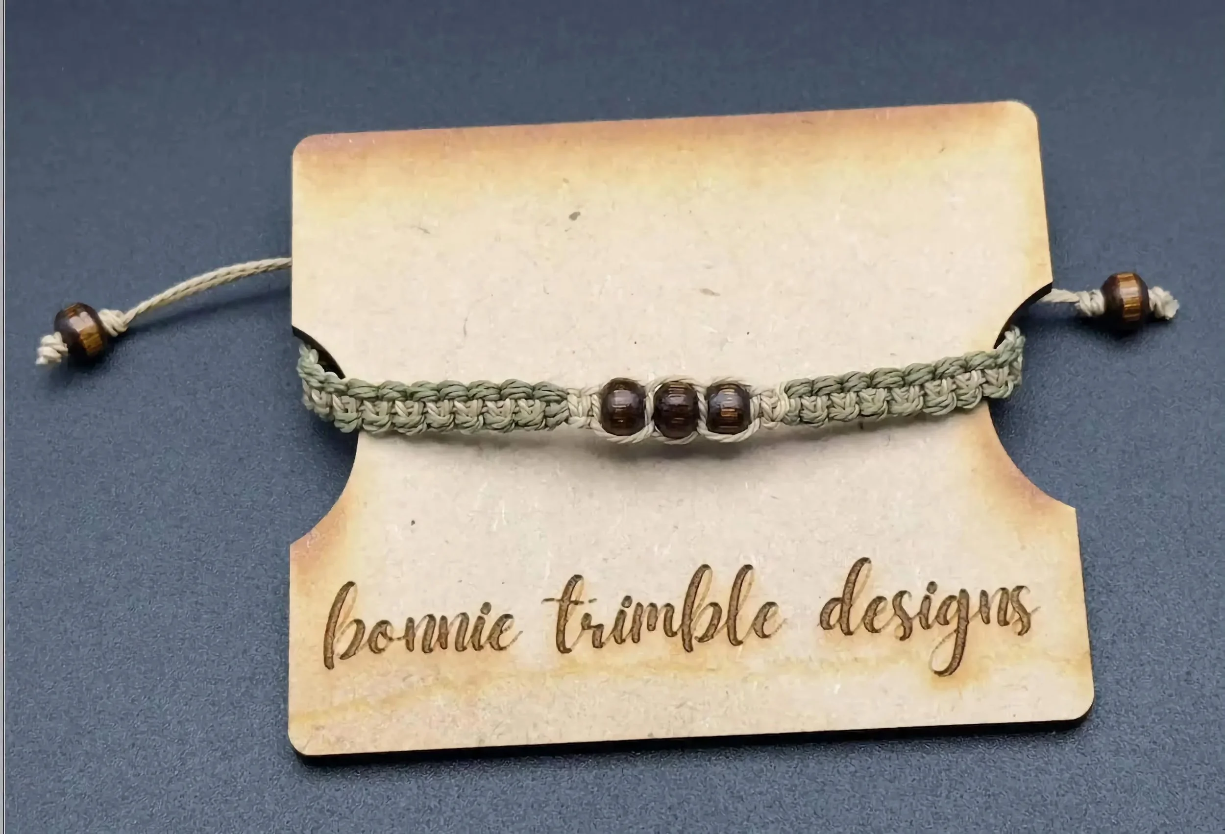 close-up of the everyday adventurer bracelet highlighting the precision of the square knots and the warm tones of the wood beads.