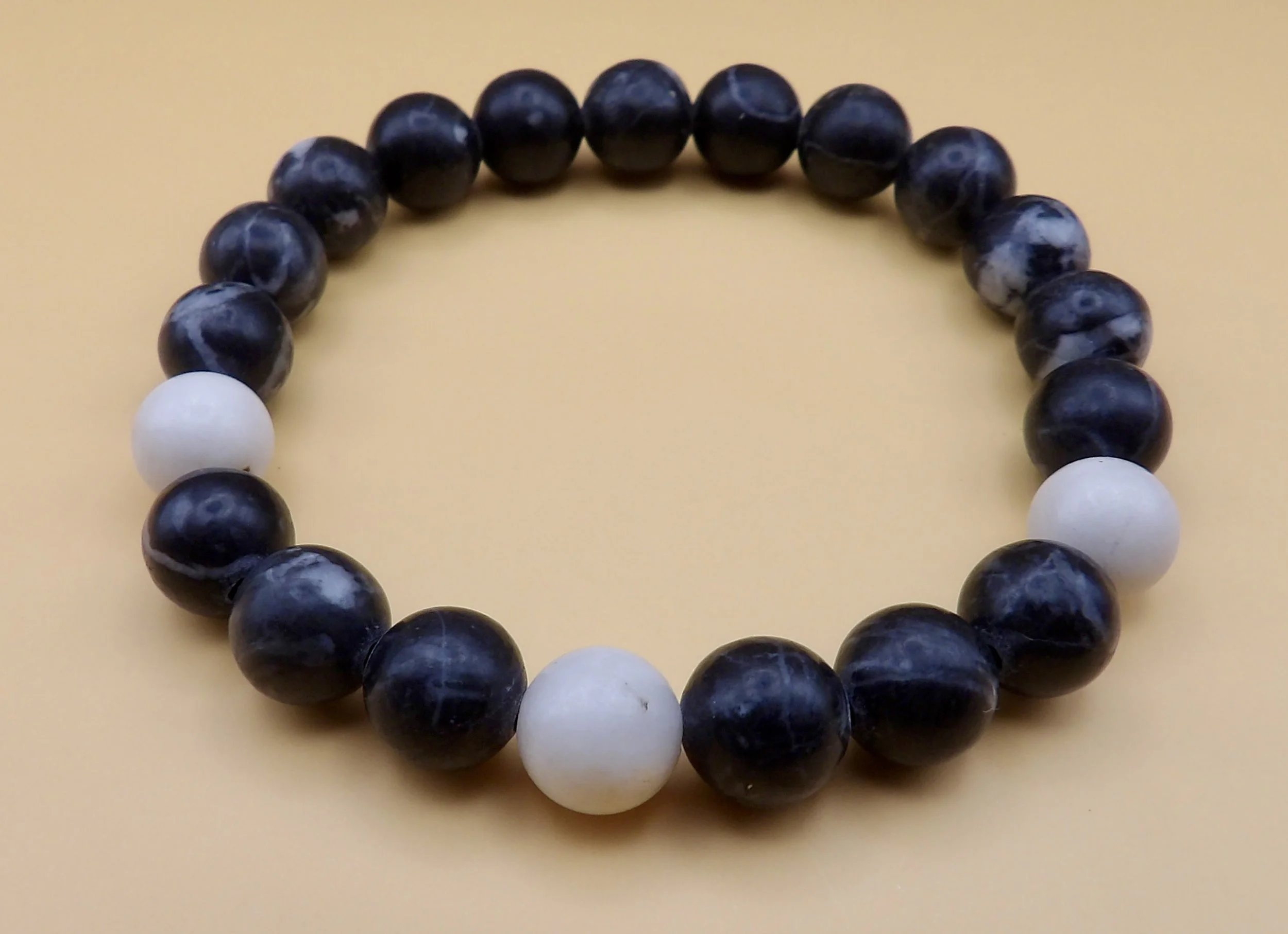 close-up detail of the natural black and white striping on the smooth round zebra jasper beads.