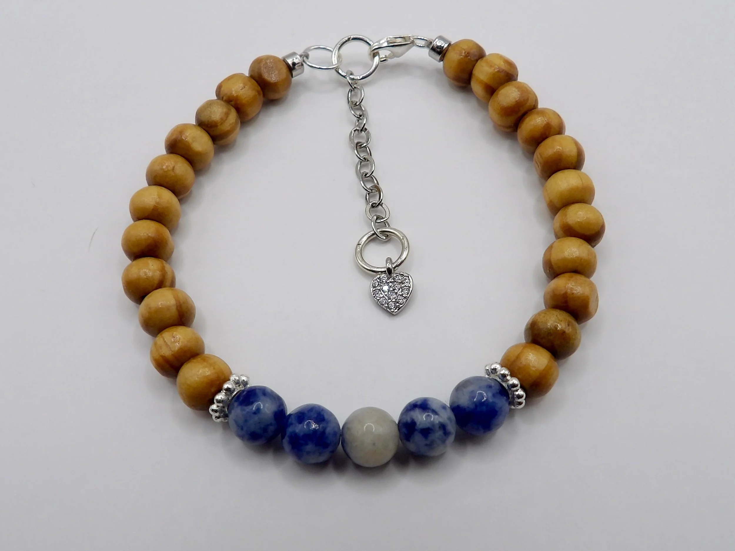 handcrafted adjustable bracelet with sterling silver accents and a signature "woodland sparkle" heart focal point.