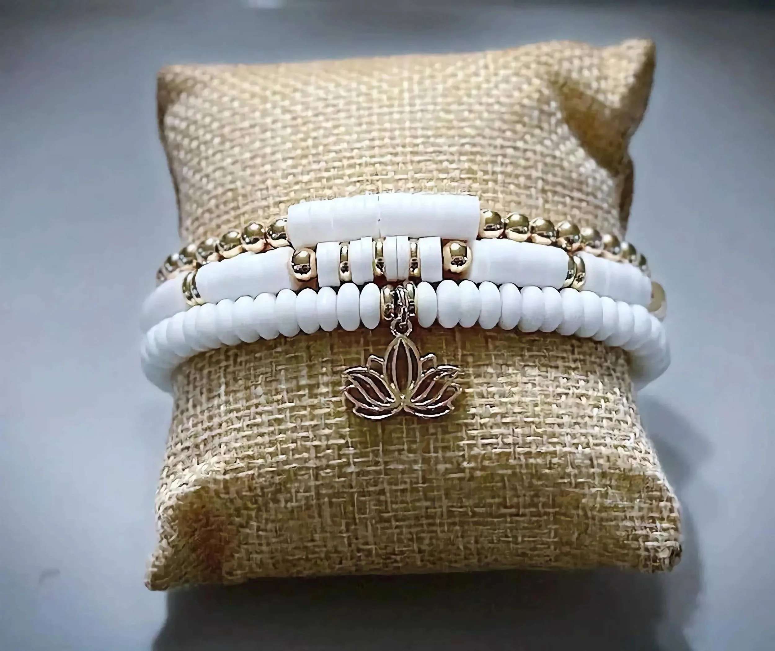 Handcrafted lotus meditation jewelry made in Pearland Texas featuring a sophisticated blend of white clay heishi and gold accents.