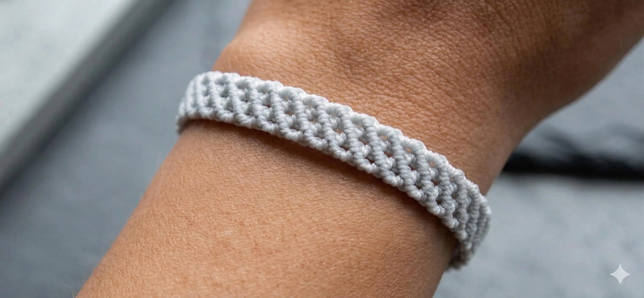 the gray layers bracelet featuring an ultra-fine 0.5mm micro-macramé weave in a sophisticated slate gray with a stainless steel clasp.