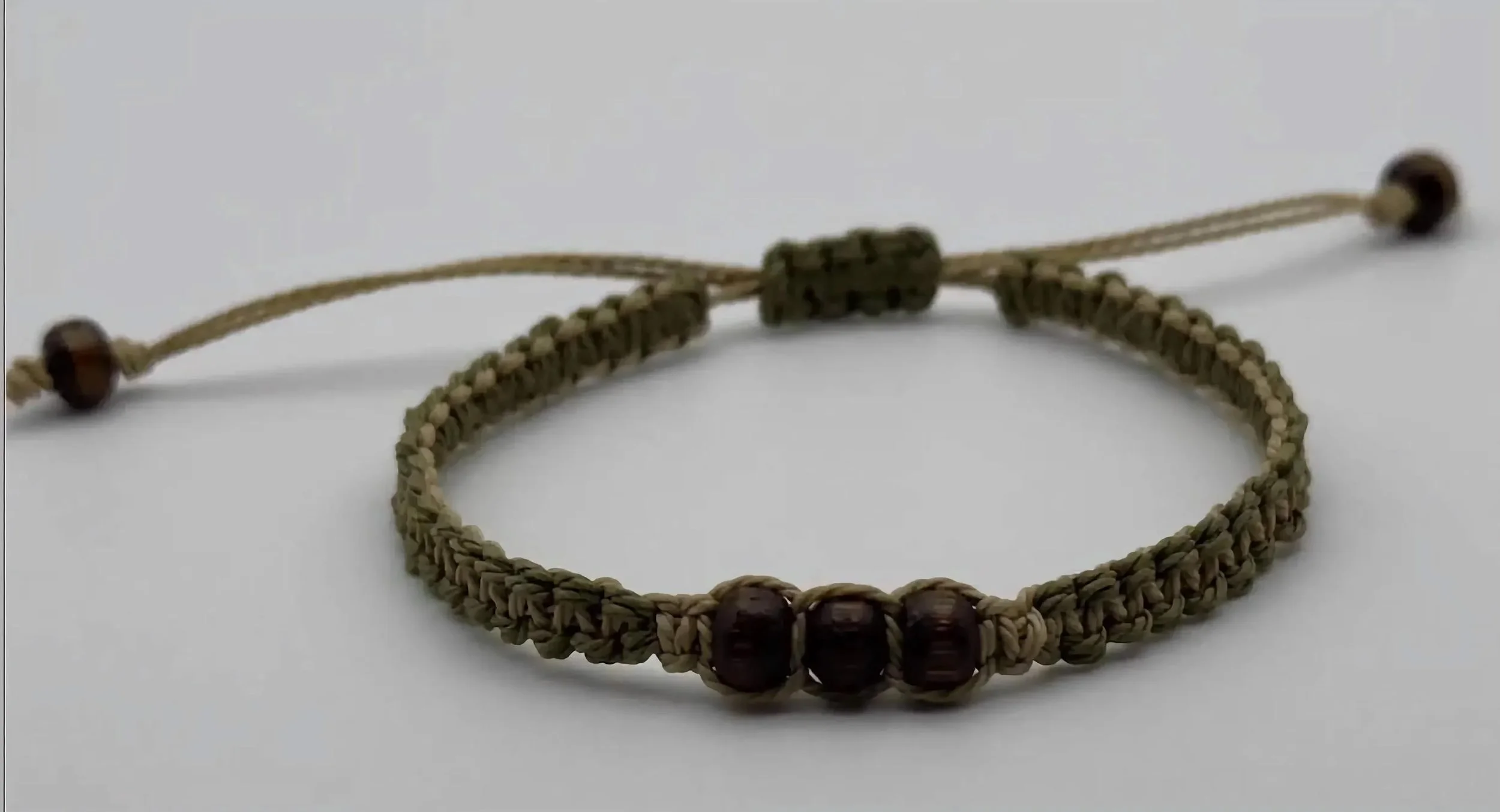 the everyday adventurer bracelet styled with outdoor gear to emphasize its durable, "gorpcore" aesthetic.