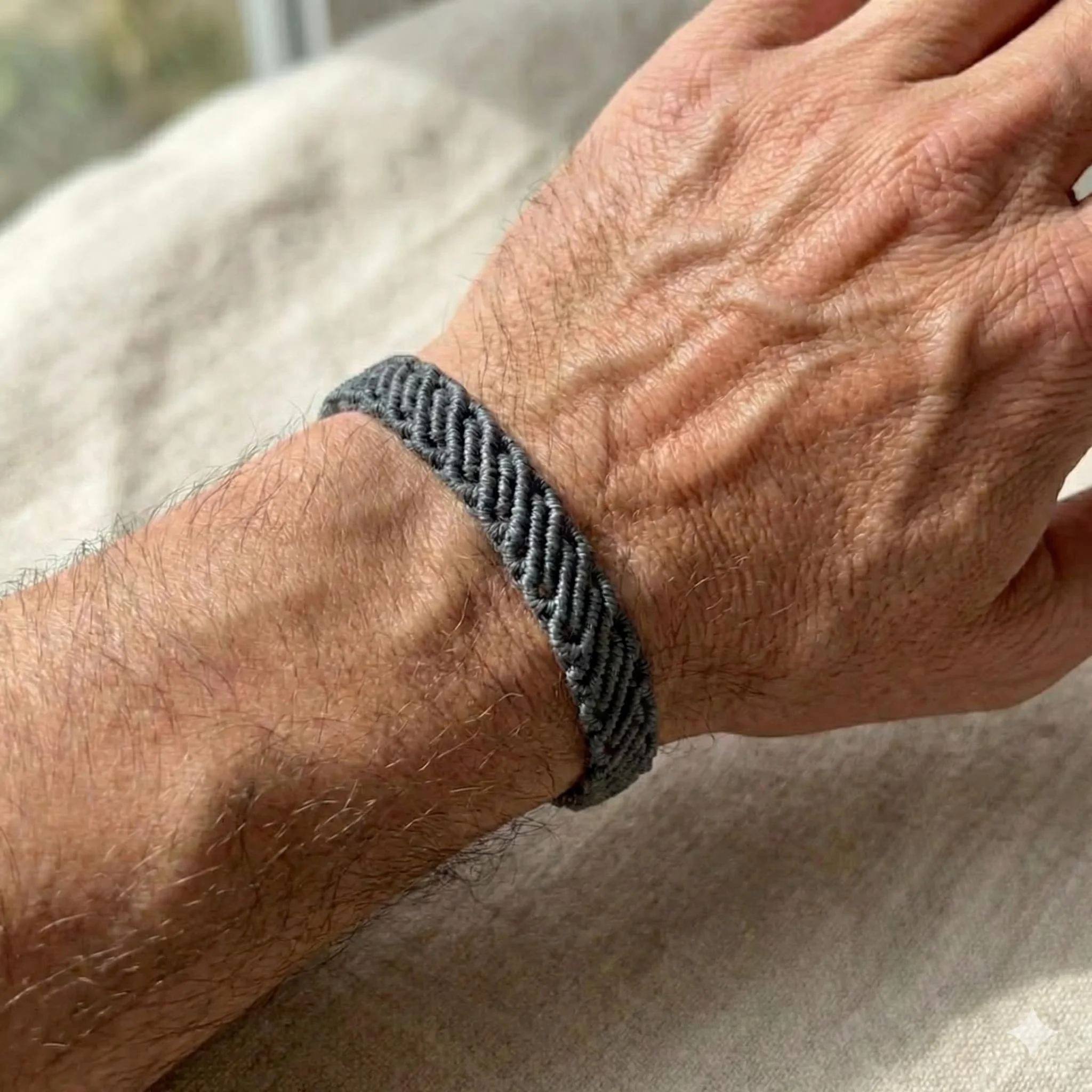 handcrafted multi-strand fiber bracelet featuring several thin rows of micro-macramé woven into a single cohesive cuff.