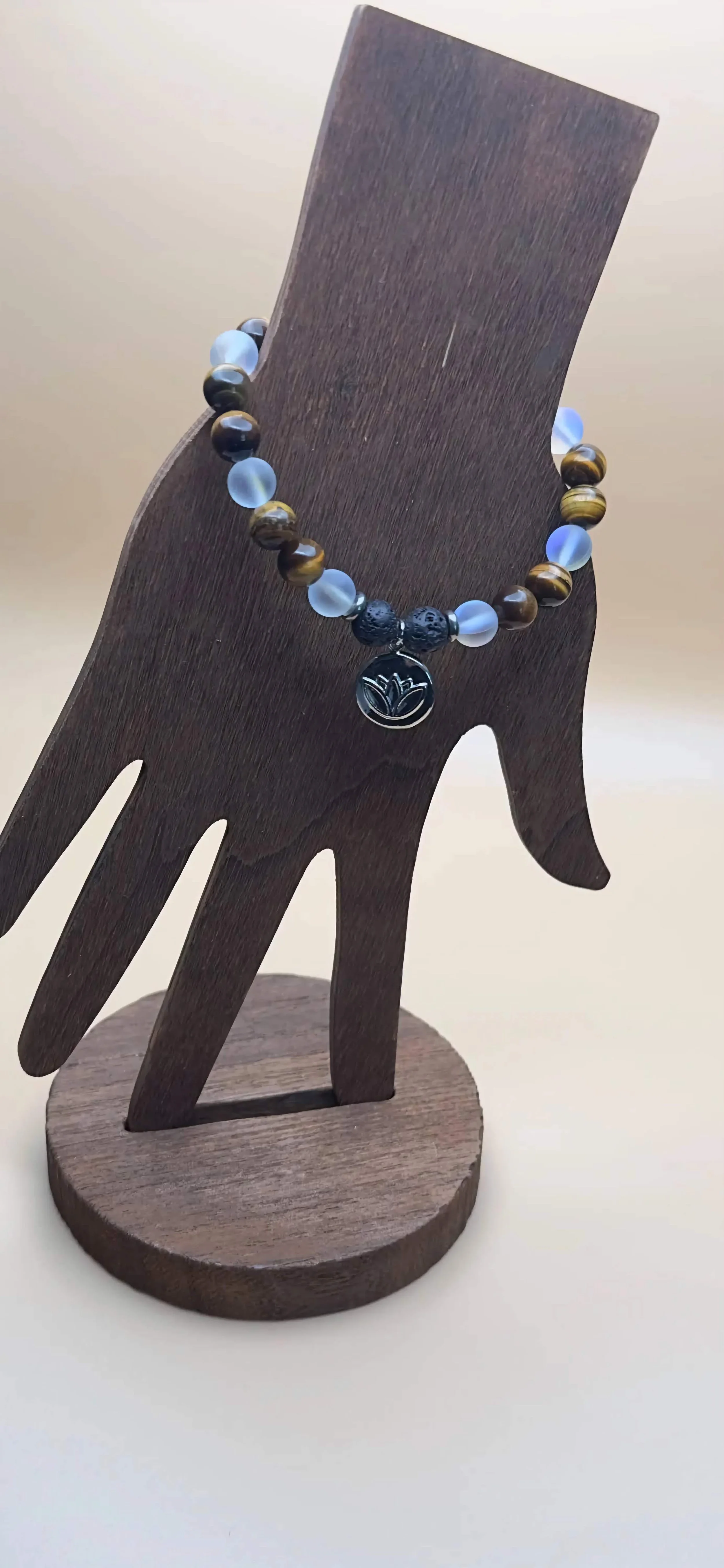 A close-up of a handmade chakra bracelet with 7 different colored gemstones.