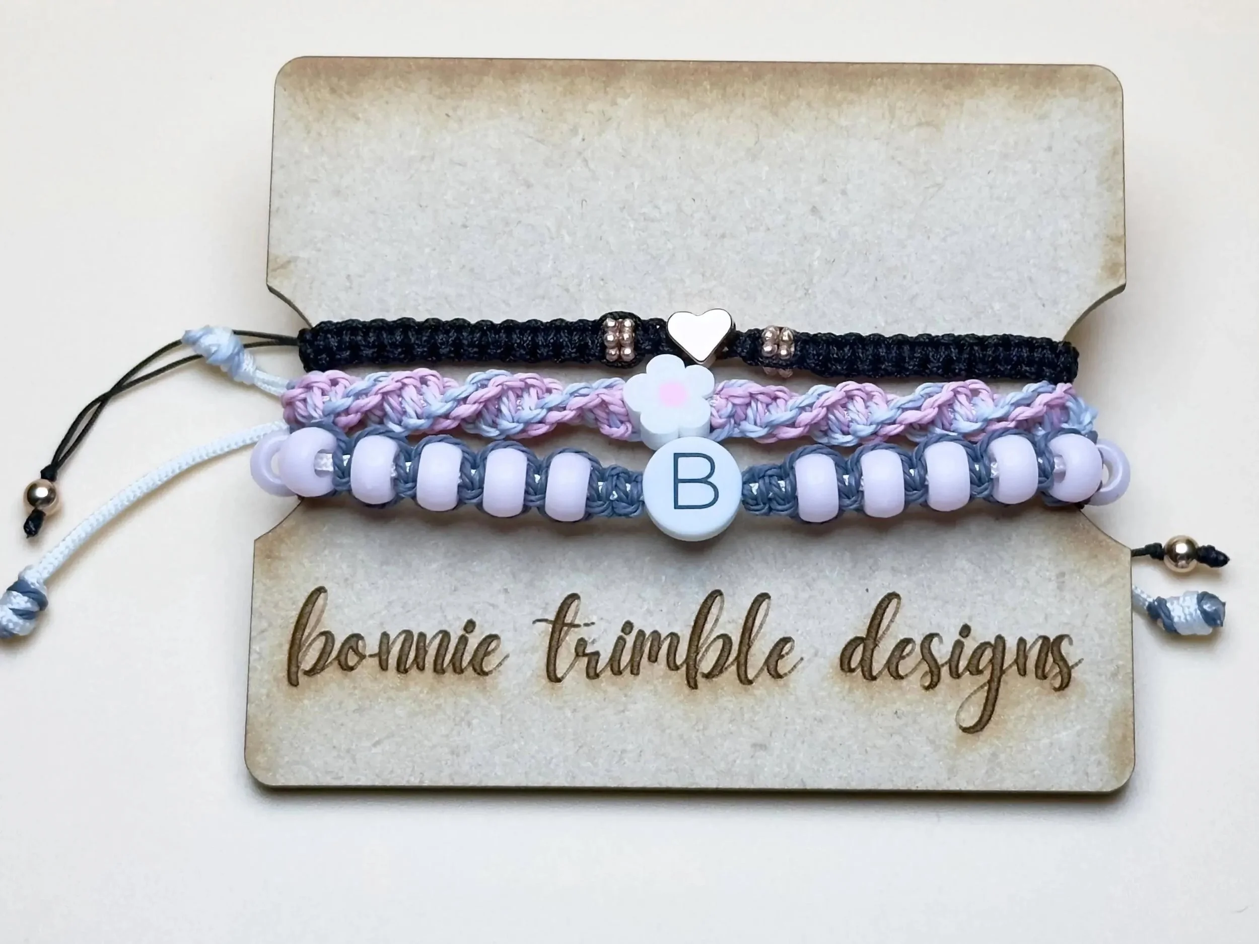 a modern personalized jewelry stack featuring three coordinating adjustable bracelets in a custom color palette.