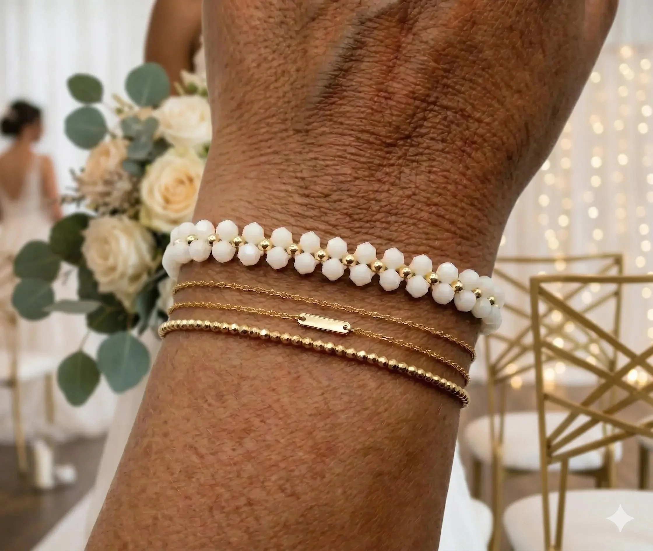 The crystal bloom bracelet featuring hand-woven daisy chains made of shimmering white bicone crystals and 18k gold plated centers.
