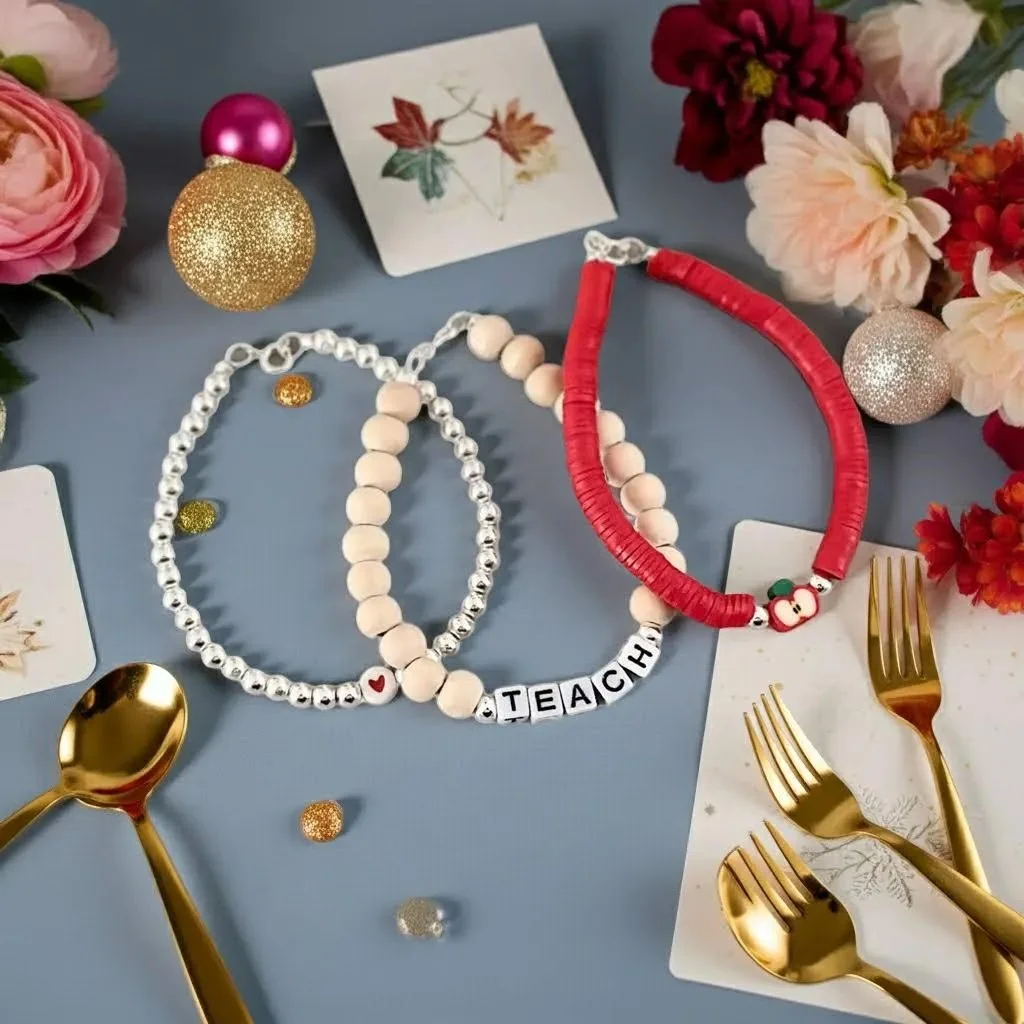 close-up of 5mm sterling silver bead bracelets with high-shine finish and custom "teach" typography for educators.