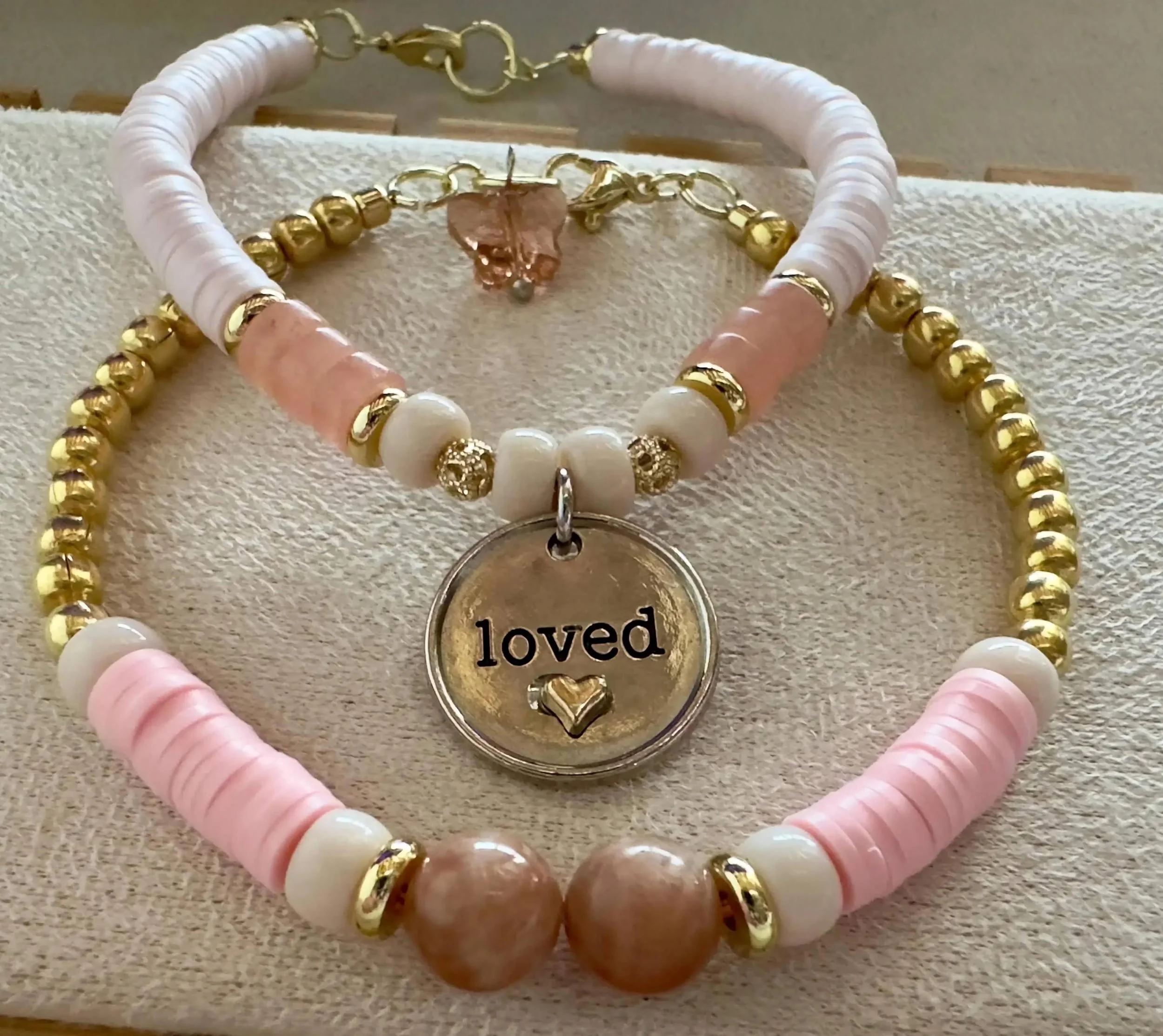 the loved and lifted set styled on a sunlit linen background to emphasize the natural glow of the crystals.