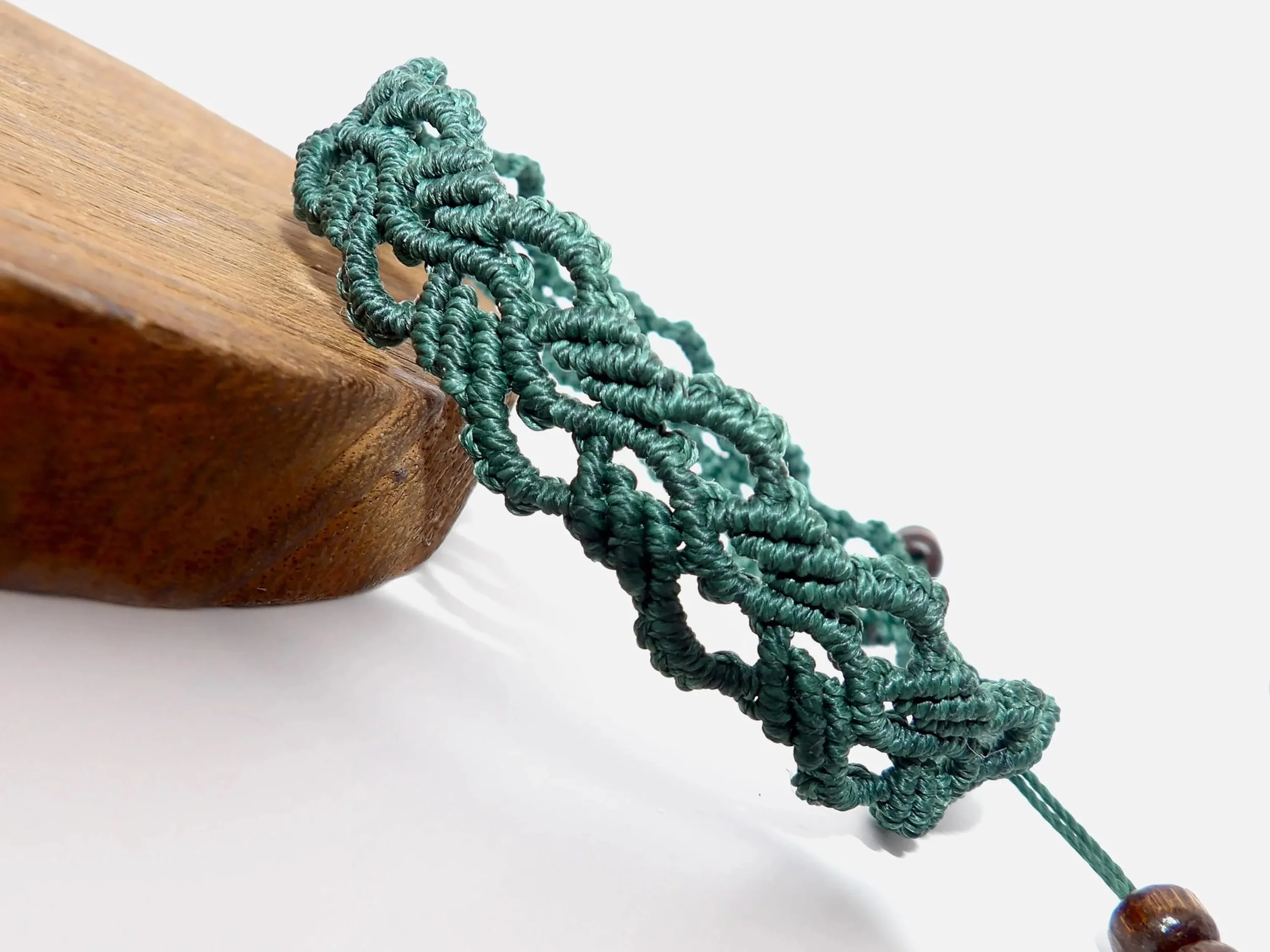an adjustable and life-proof botanical anchor bracelet featuring high-performance cord and a signature brand weave.