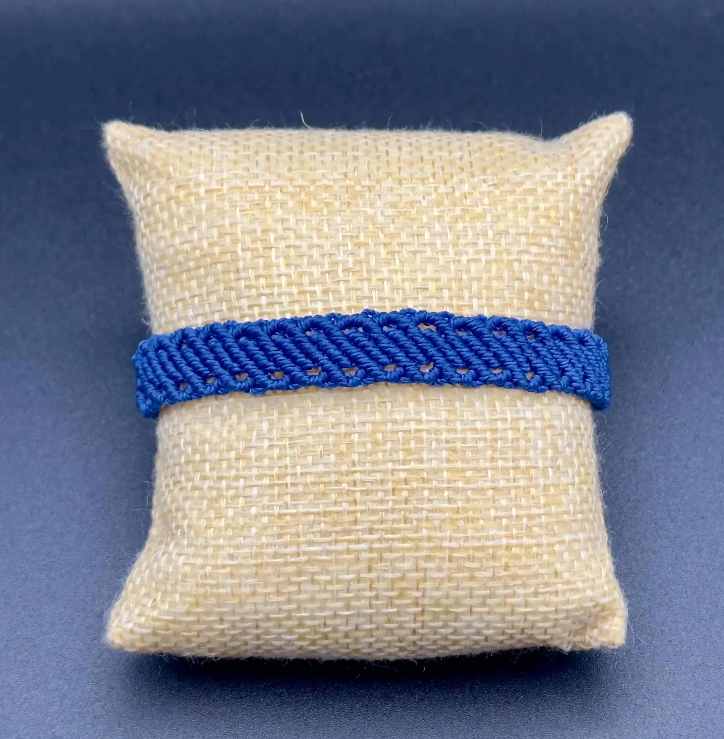 adjustable micro-macramé cuff designed to look like a perfectly curated stack of individual thin cord bracelets.